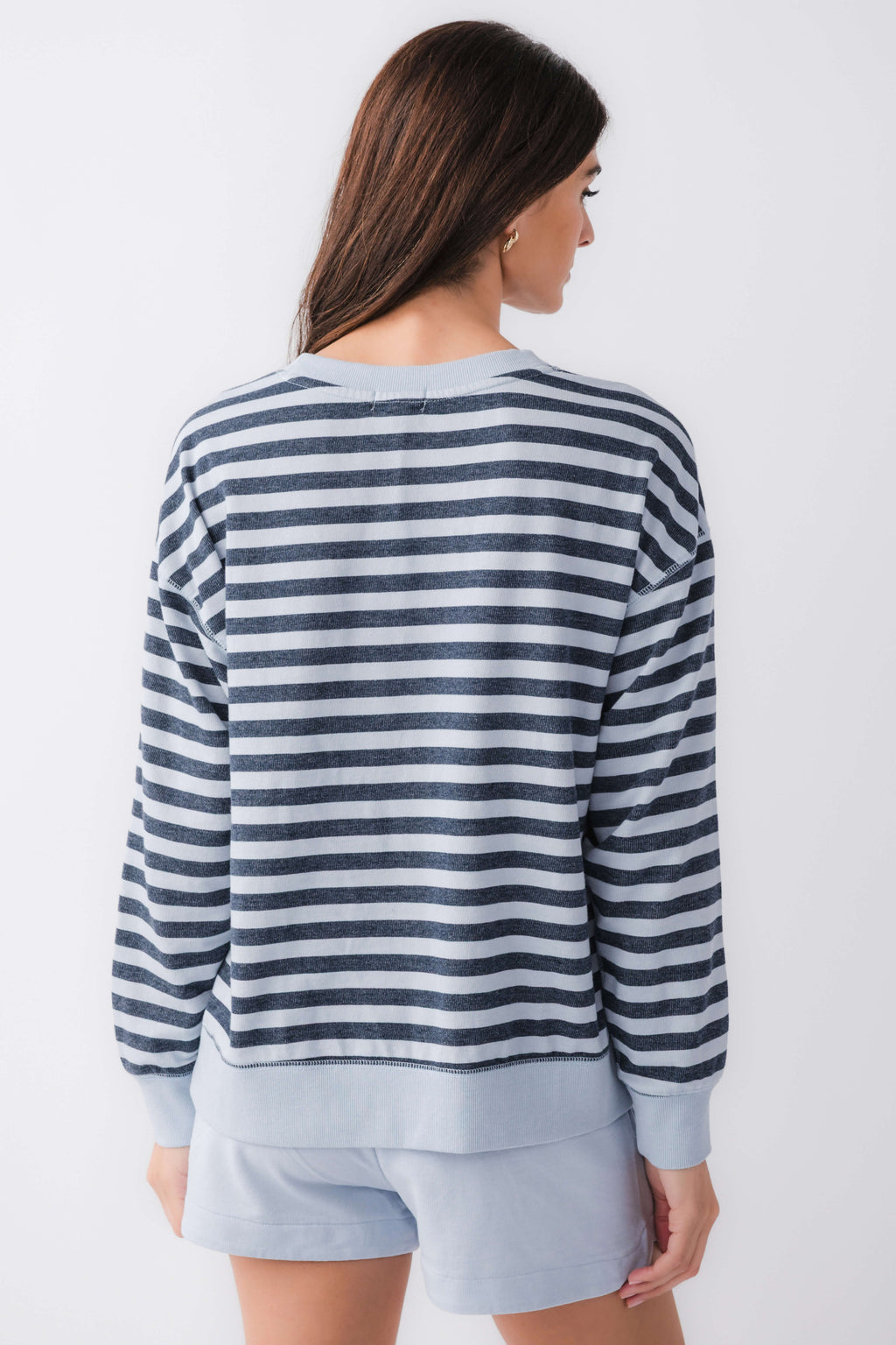 Women’s striped crewneck sweatshirt in navy and white, back view with long sleeves