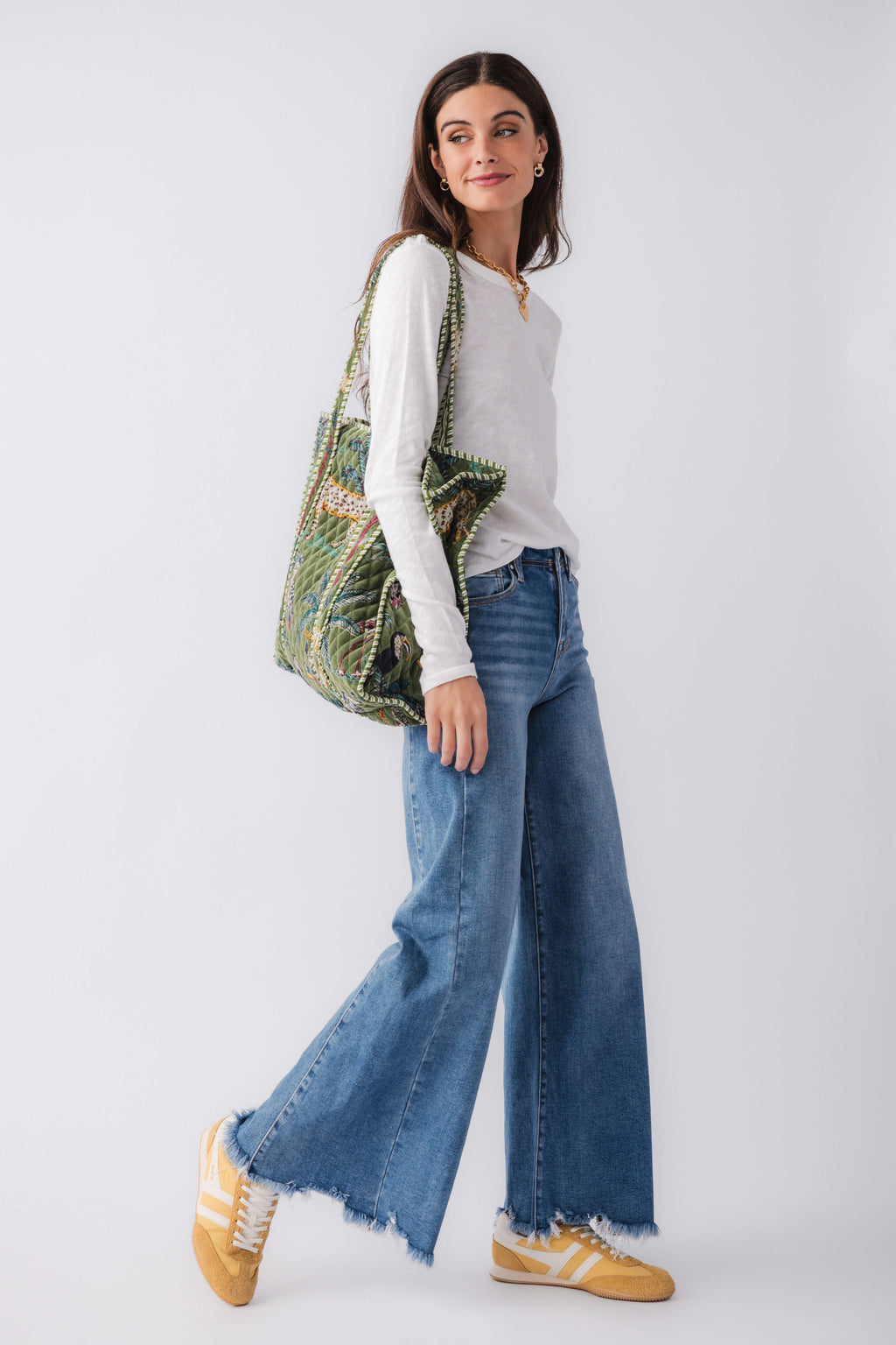 Green quilted tote with patchwork animal print, striped handles, open side view