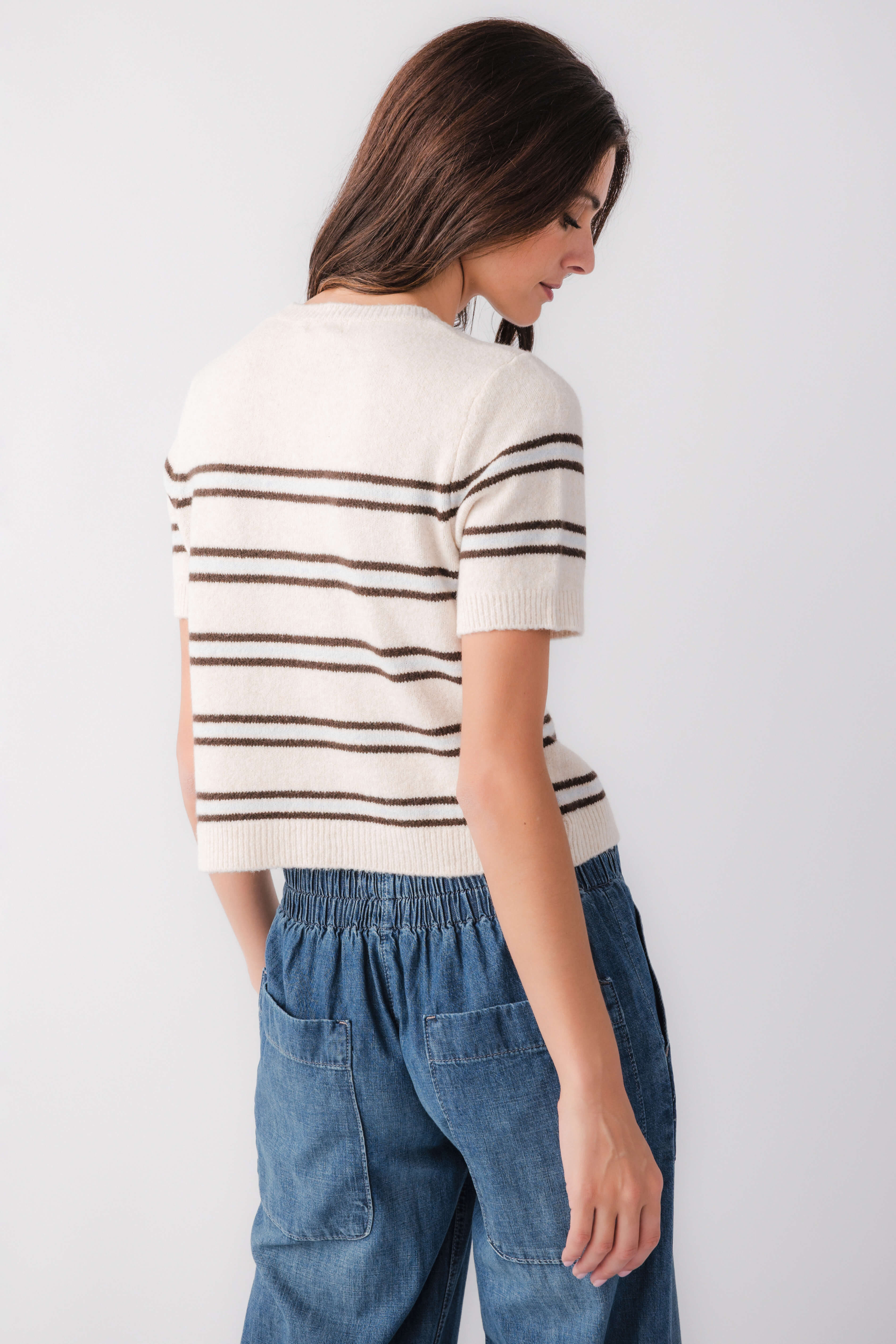 Light oatmeal heather striped knit sweater, short sleeves, back view with ribbed hem
