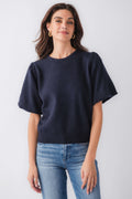 Navy knit bubble-sleeve top with relaxed fit and cuffed short sleeves