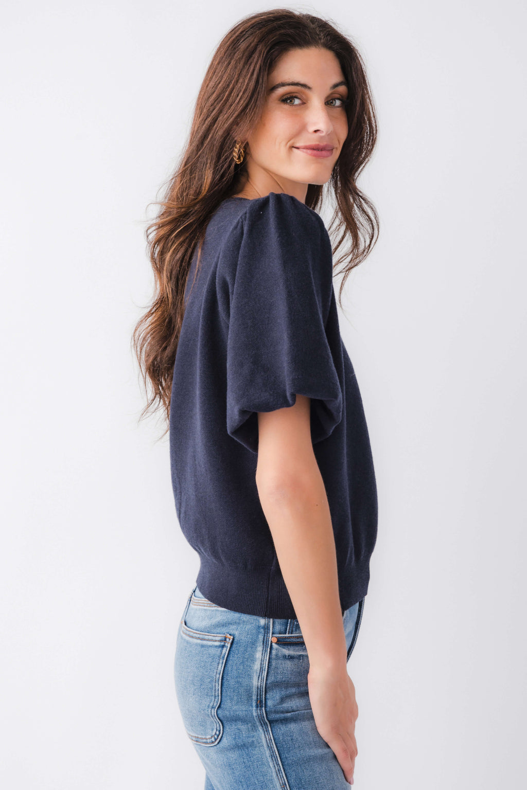 Navy solid knit bubble-sleeve top in a side view, crew neck