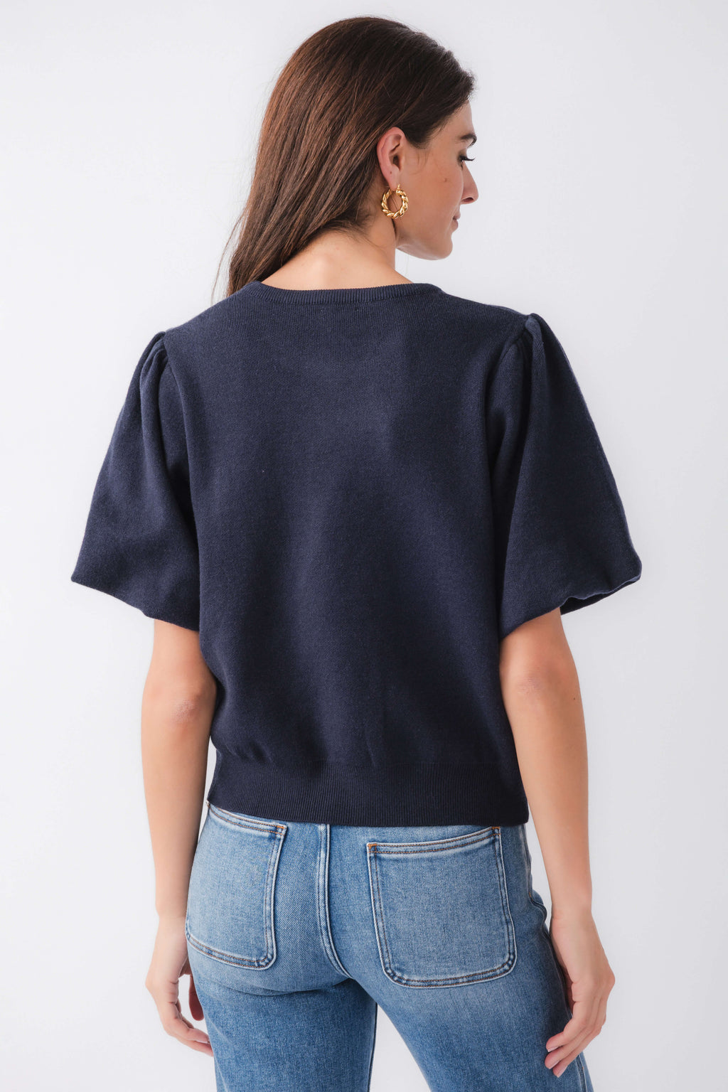 Navy knit bubble-sleeve top, back view with short wide sleeves