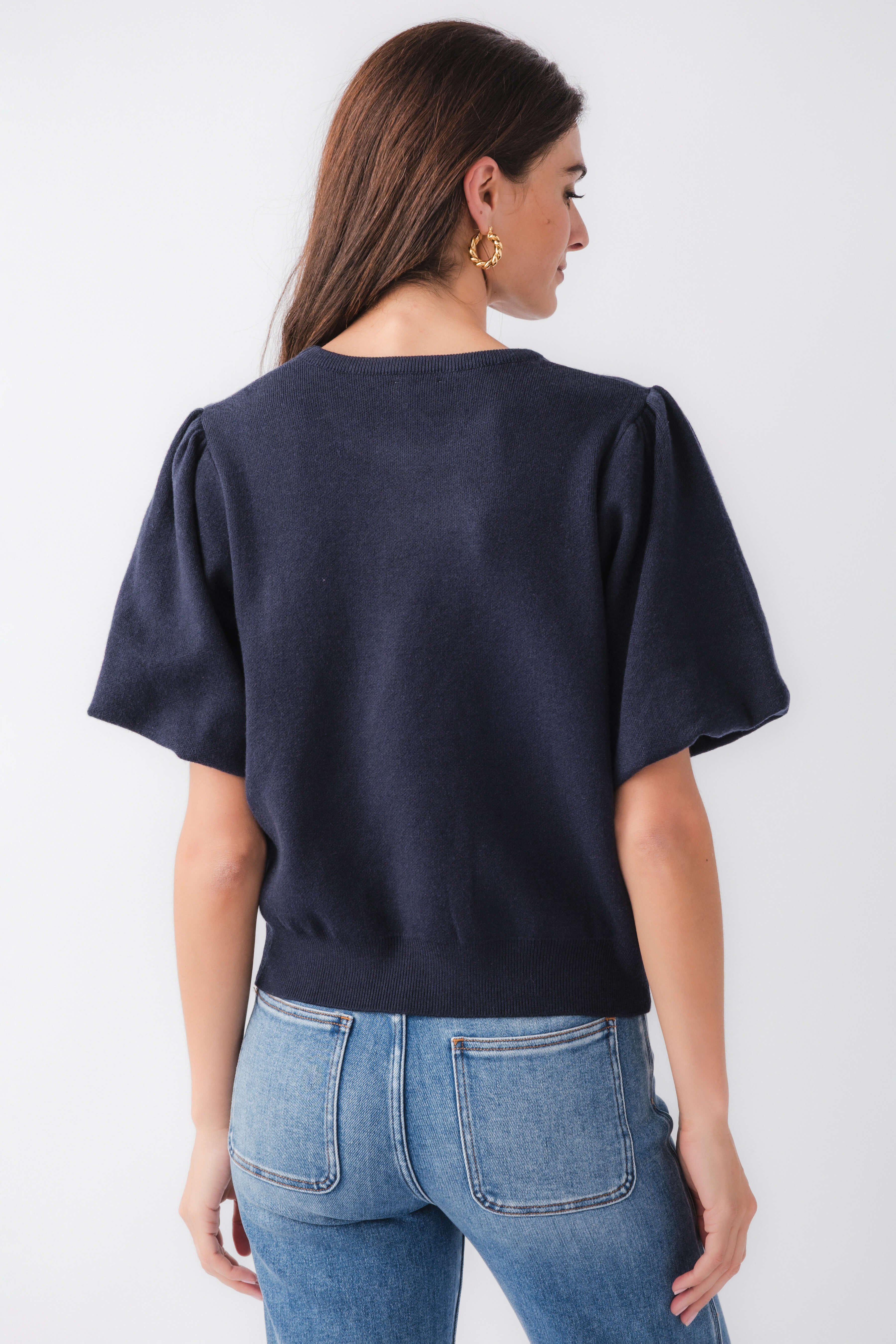 Navy knit bubble-sleeve top, back view with short wide sleeves