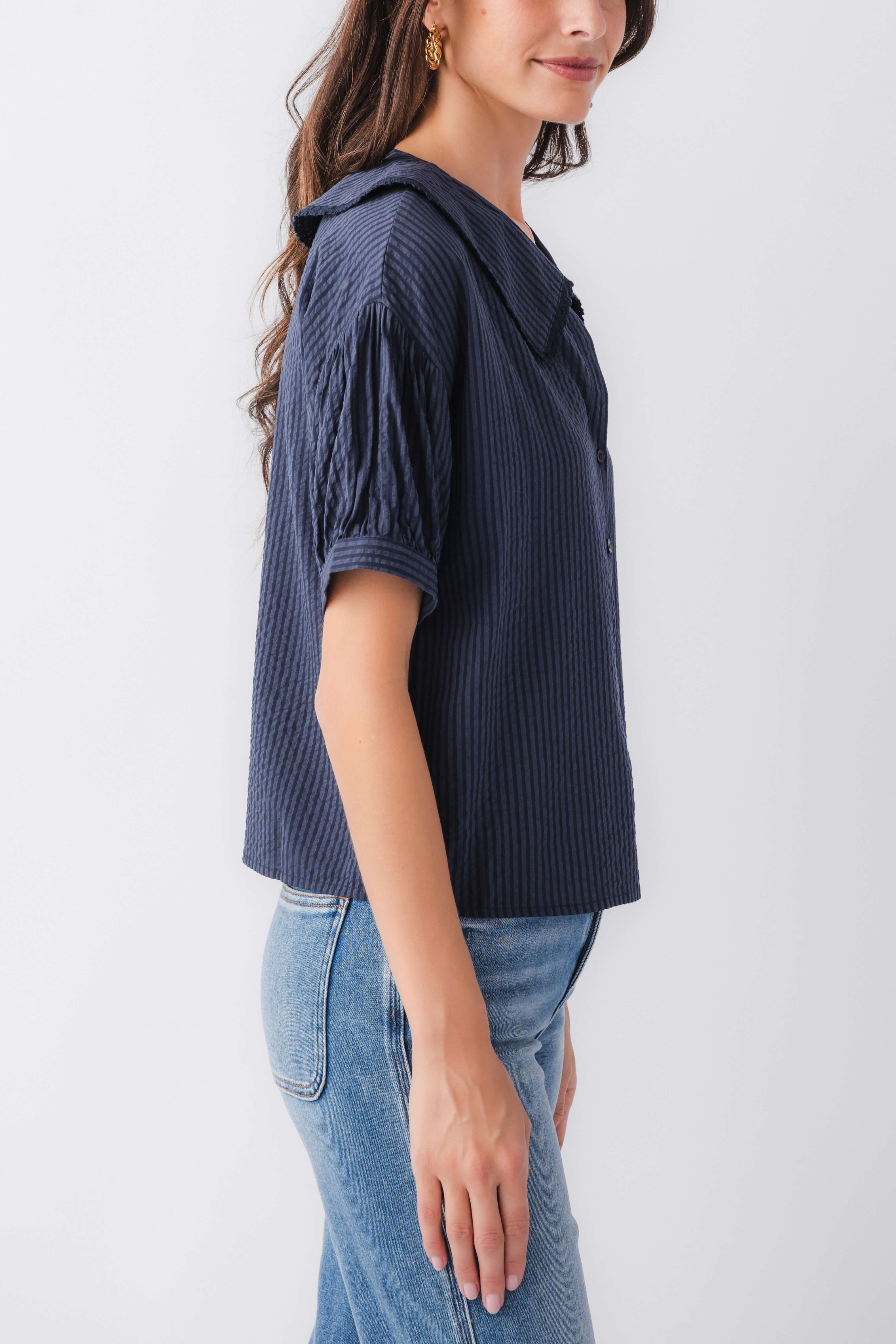 Midnight blue pinstripe short-sleeve top with peter pan collar, side view