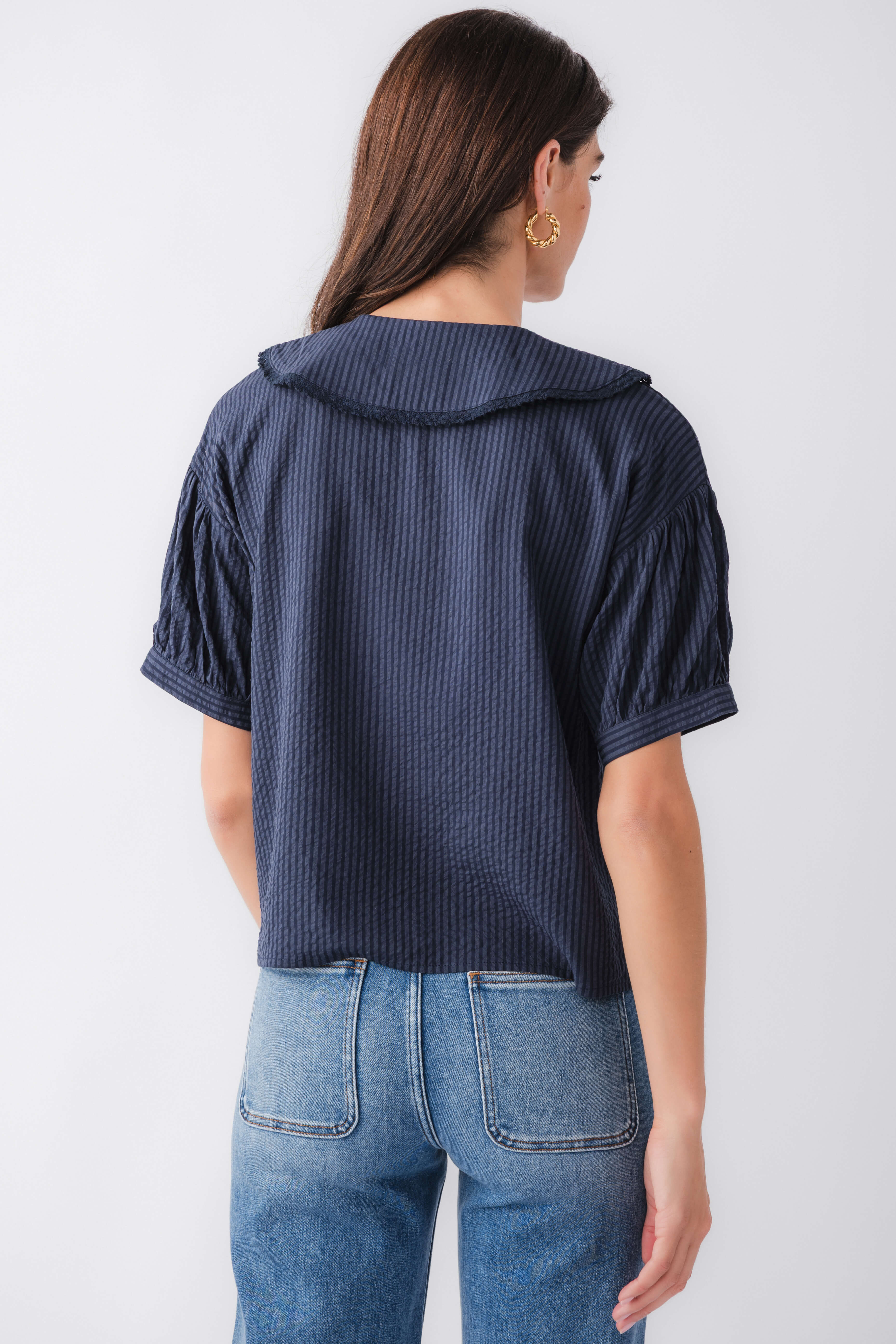 Midnight blue striped short-sleeve top with peter pan collar, back view