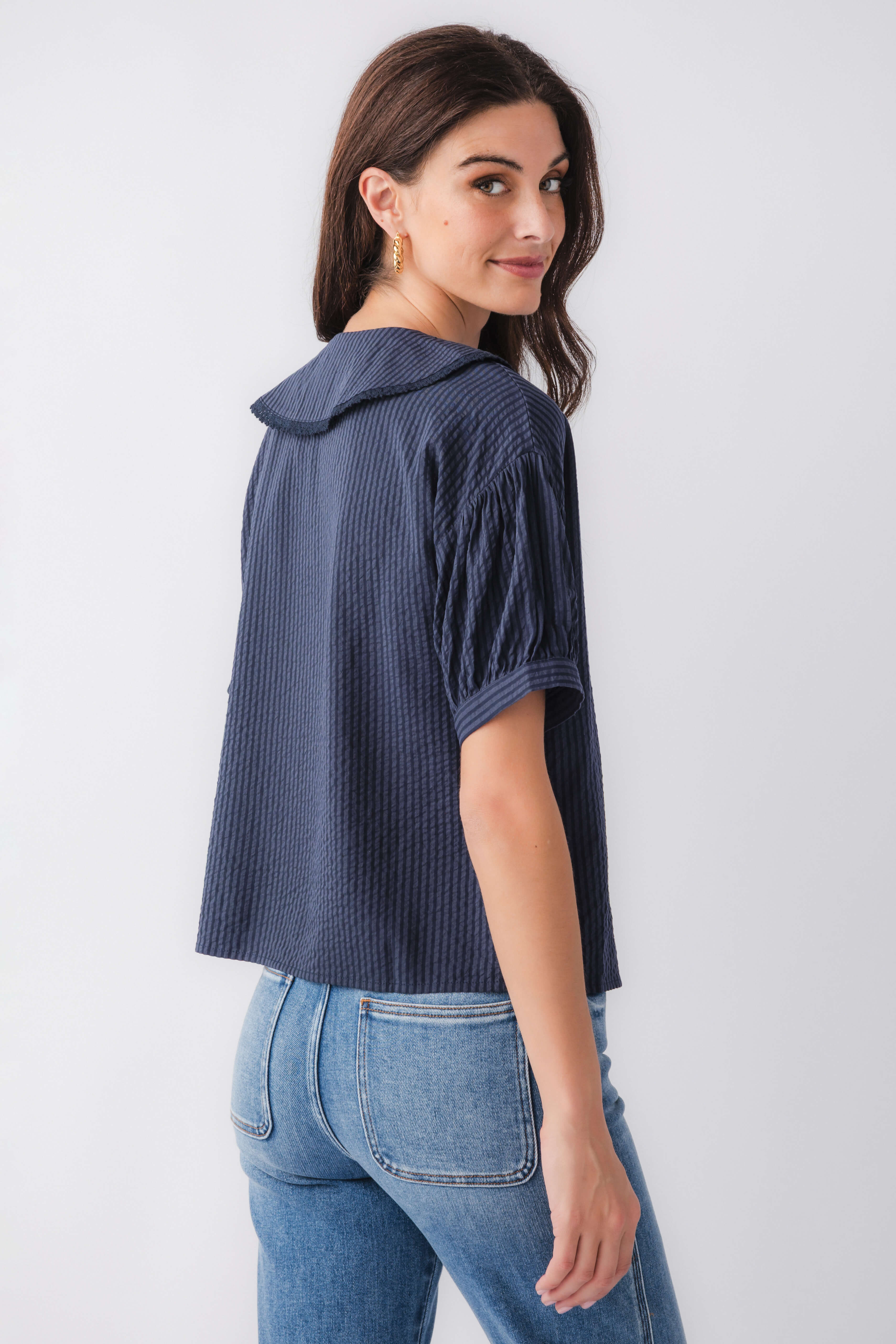 Midnight blue striped short-sleeve top with peter pan collar and button front, profile