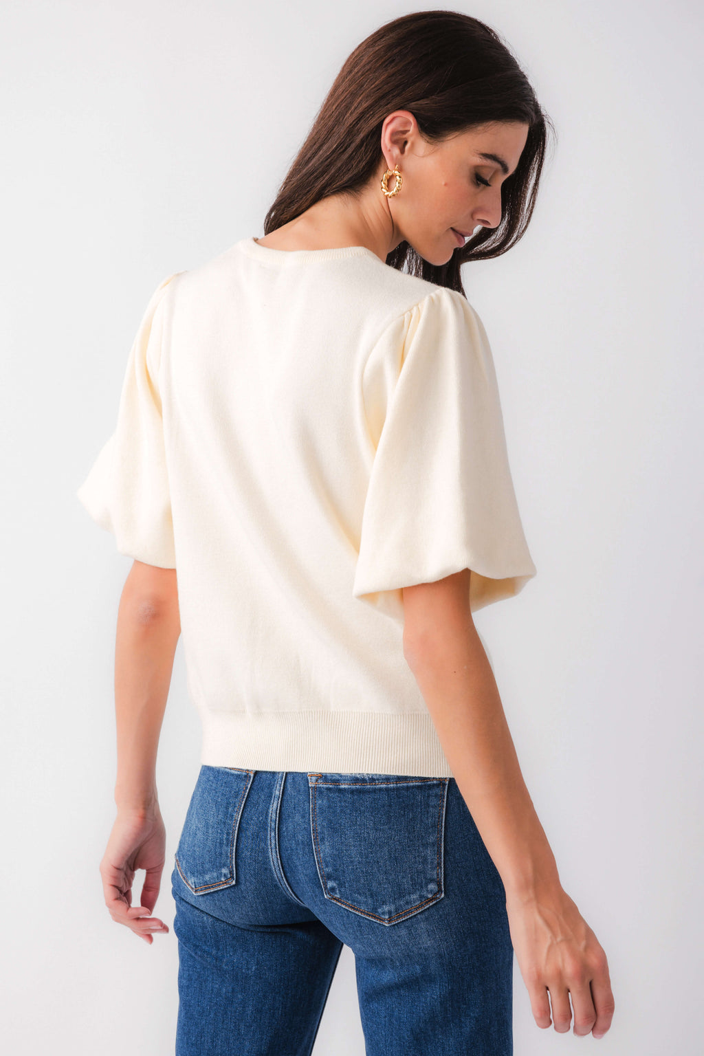 Cream solid knit bubble-sleeve top, back view with short wide sleeves
