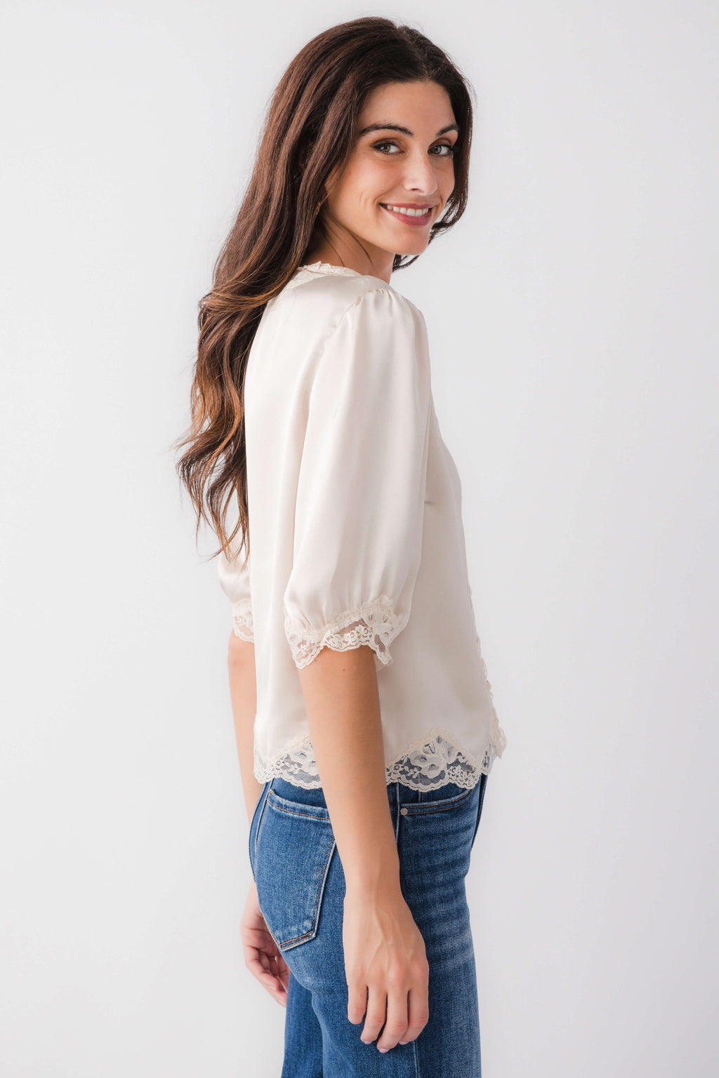 Ecru lace trim blouse top with puff sleeves and button-front, side view
