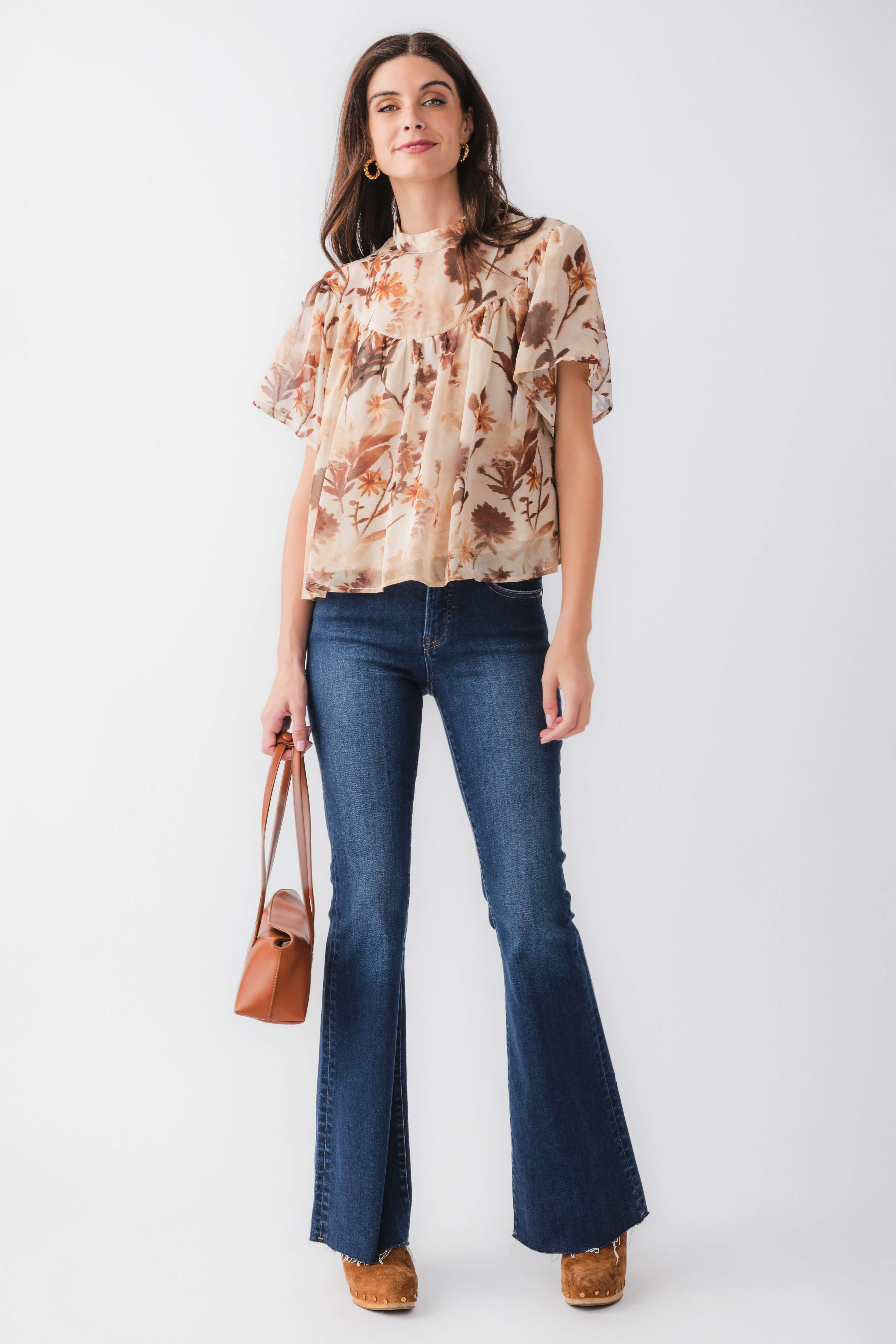 Tan floral blouse top with ruffled neckline and short sleeves, full front view