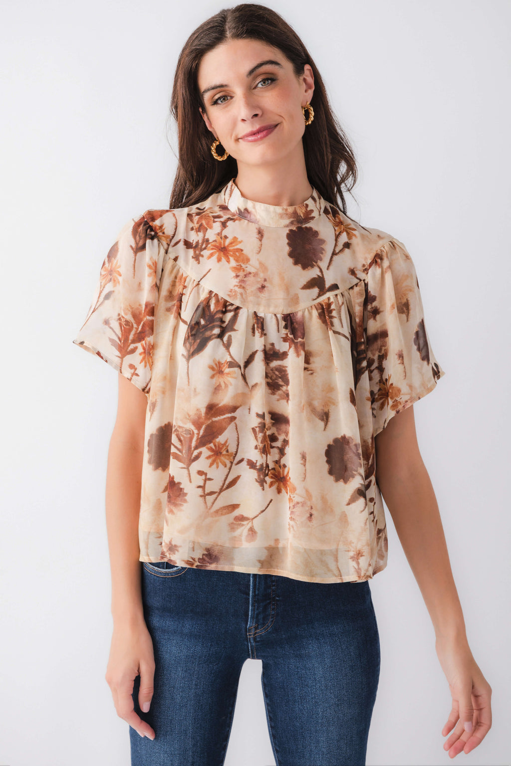 Tan floral short-sleeve blouse with ruffled high neckline