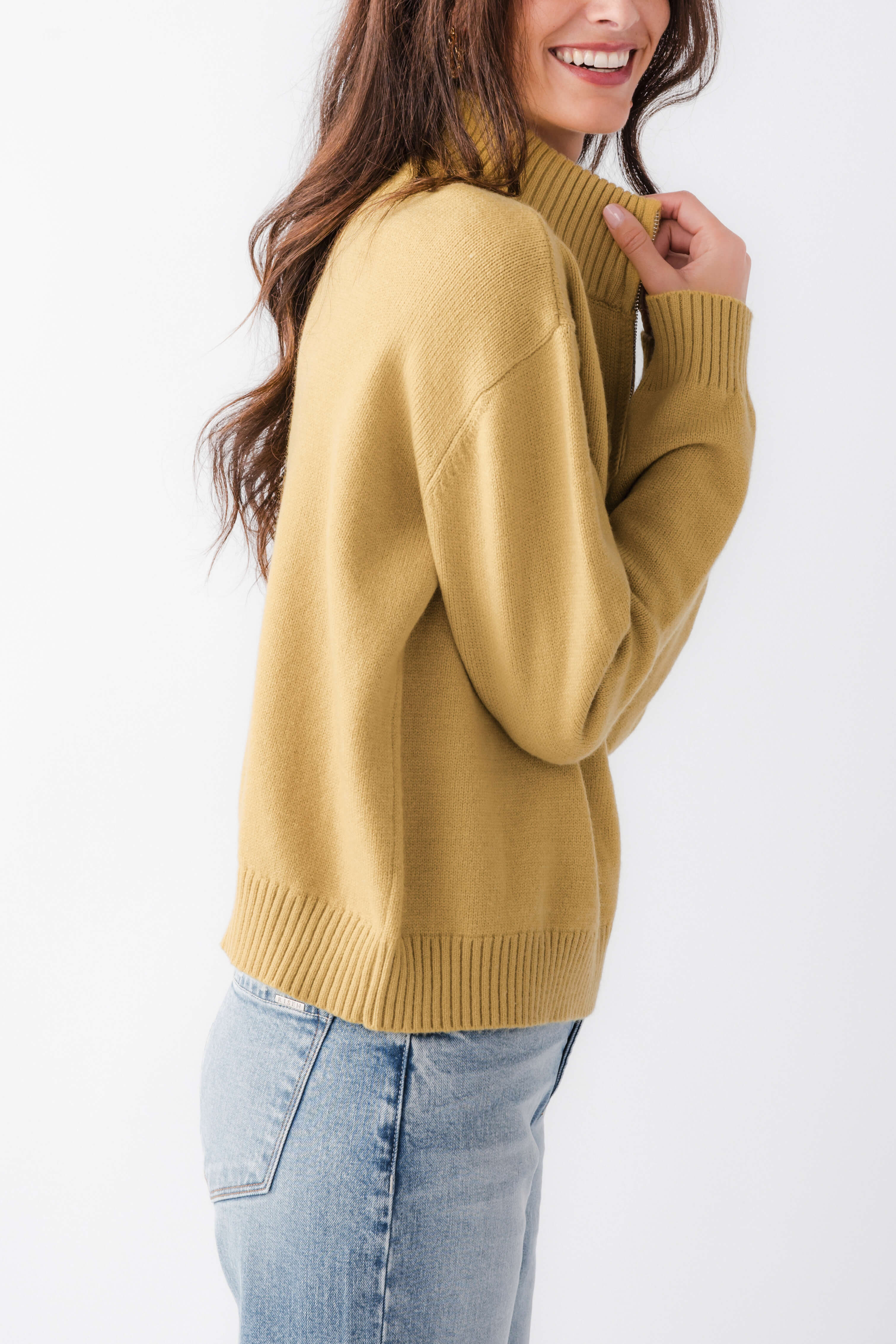 Women's gold half-zip turtleneck sweater, side profile with ribbed cuffs and hem