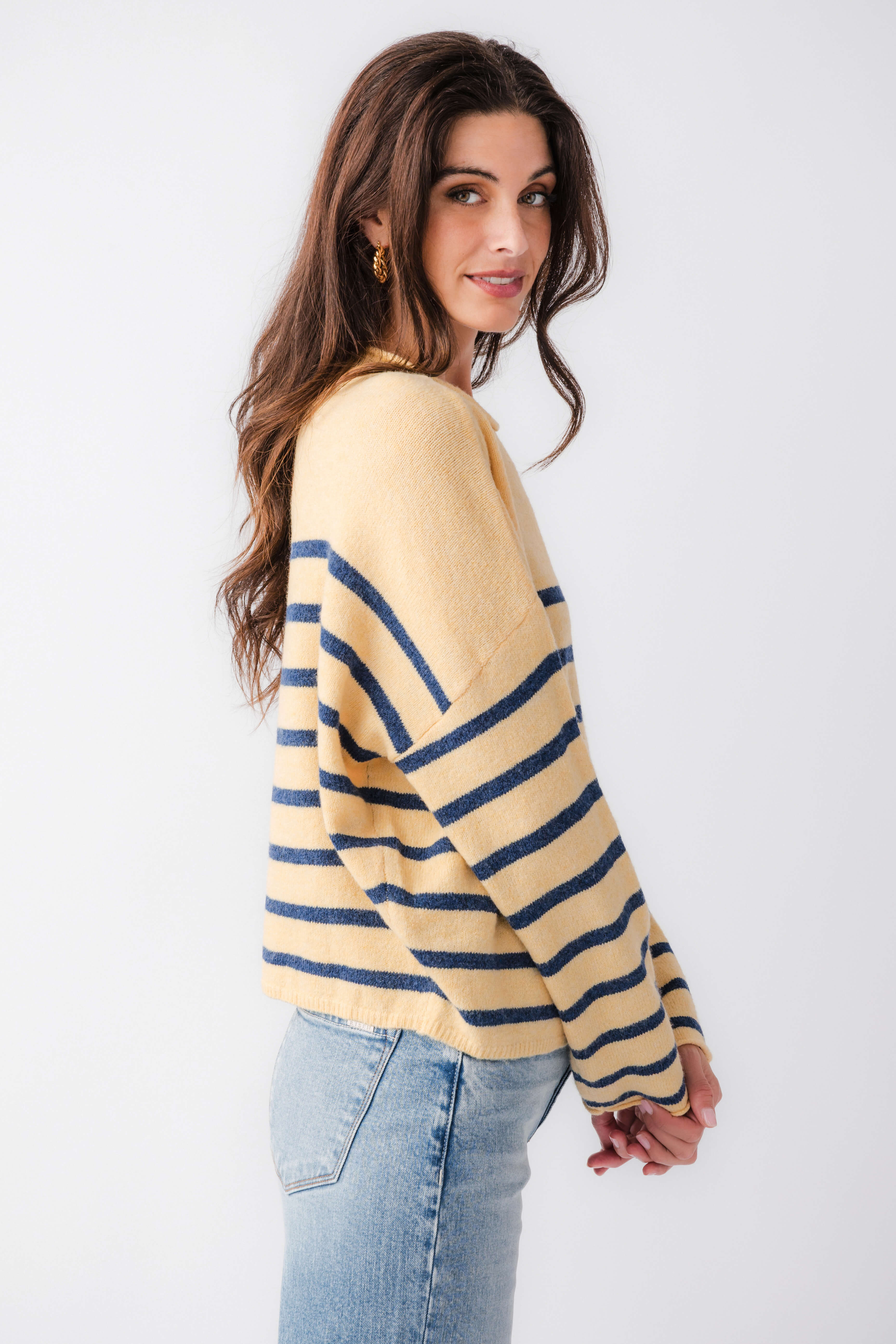 Side view of butter yellow striped mockneck sweater with navy horizontal bands