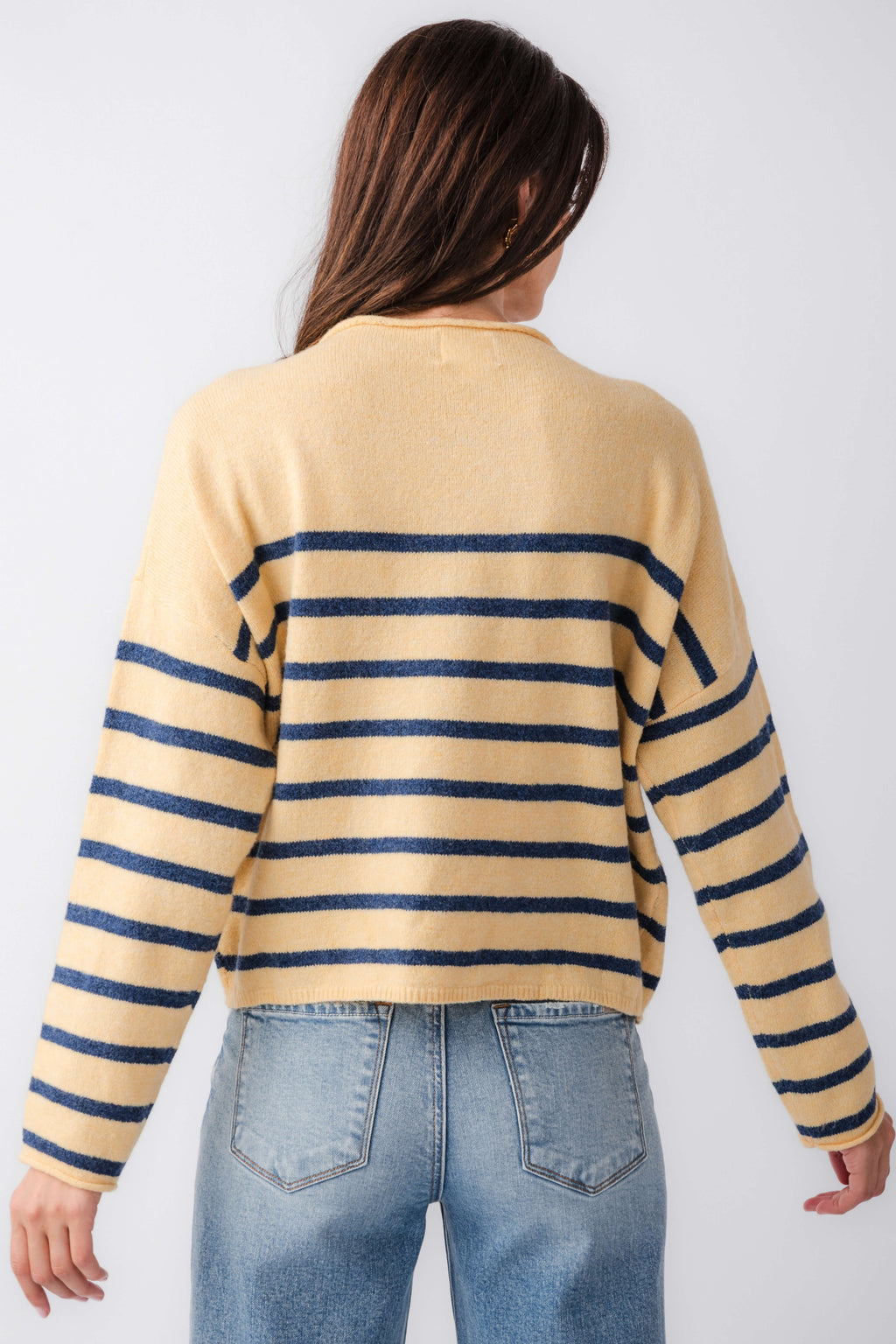 Back view of butter yellow striped mockneck sweater with navy horizontal bands