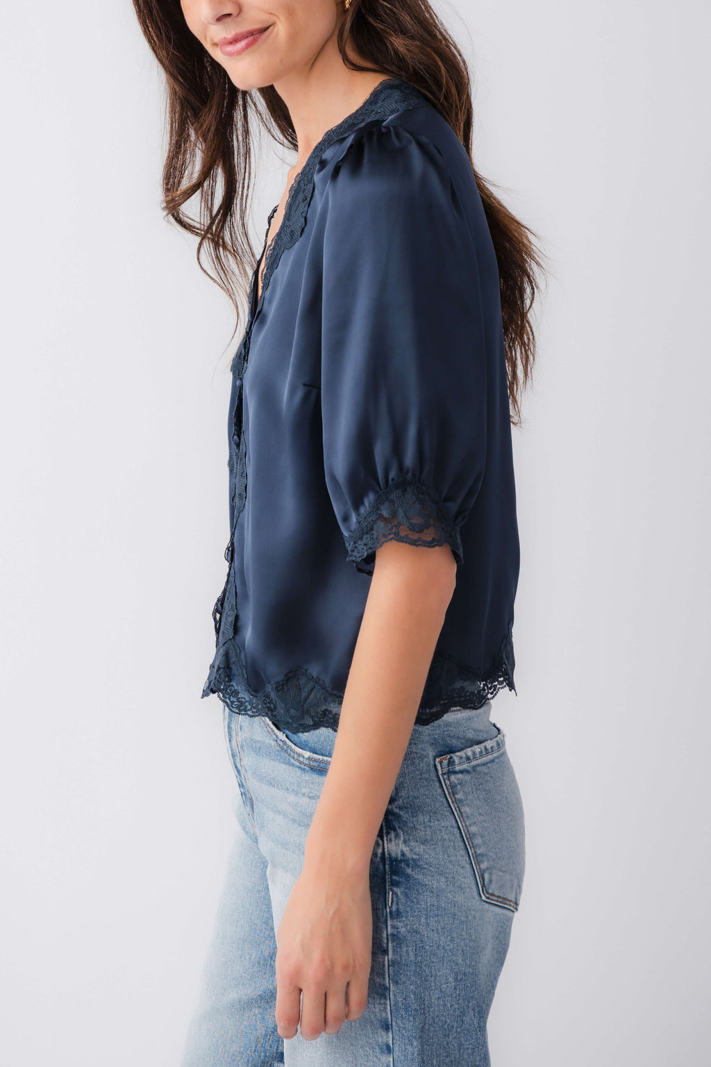 Navy satin lace-trim blouse with puff sleeves and button-front, side view