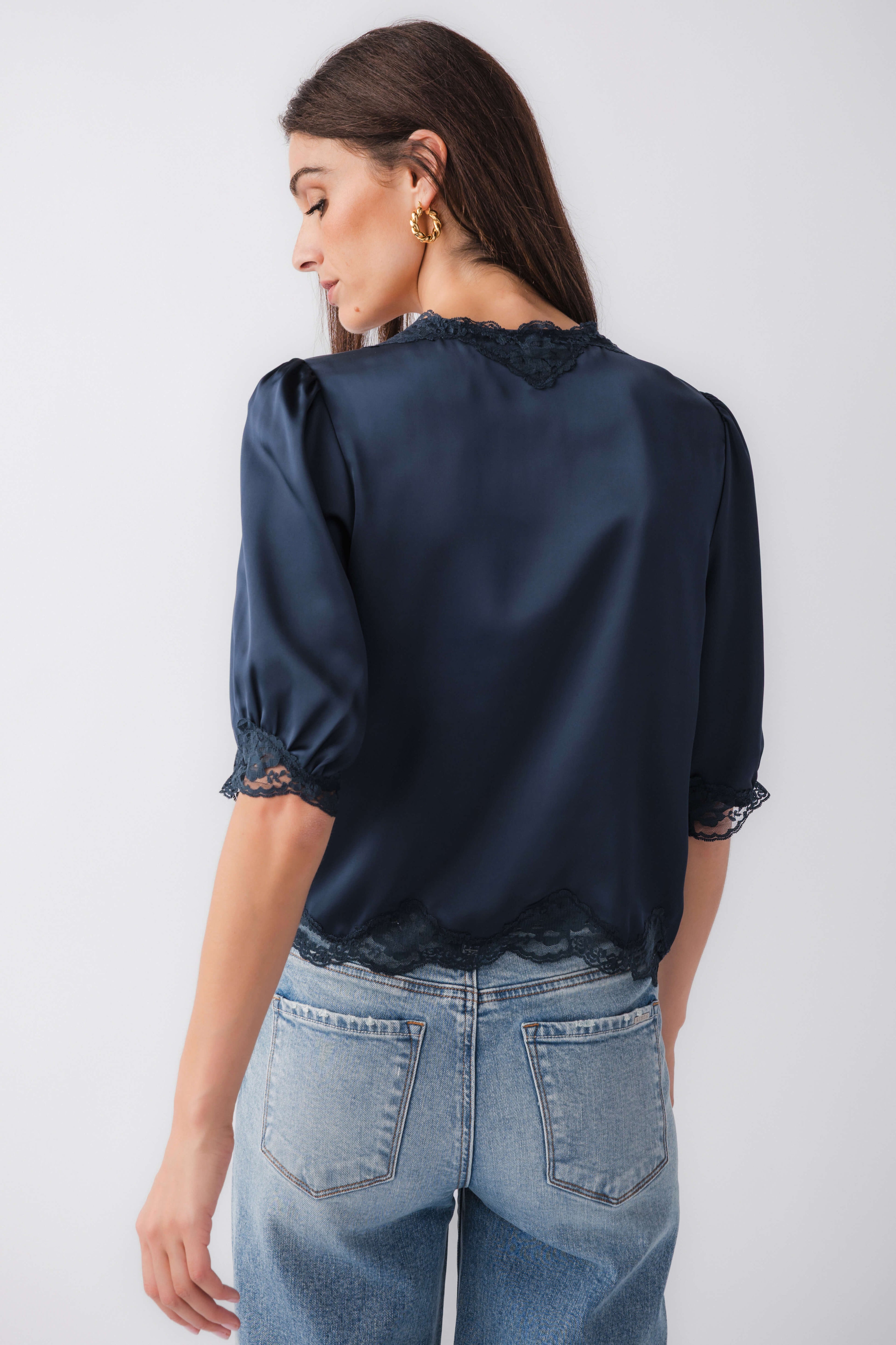 Navy satin lace-trim blouse with lace cuffs and hem, back view