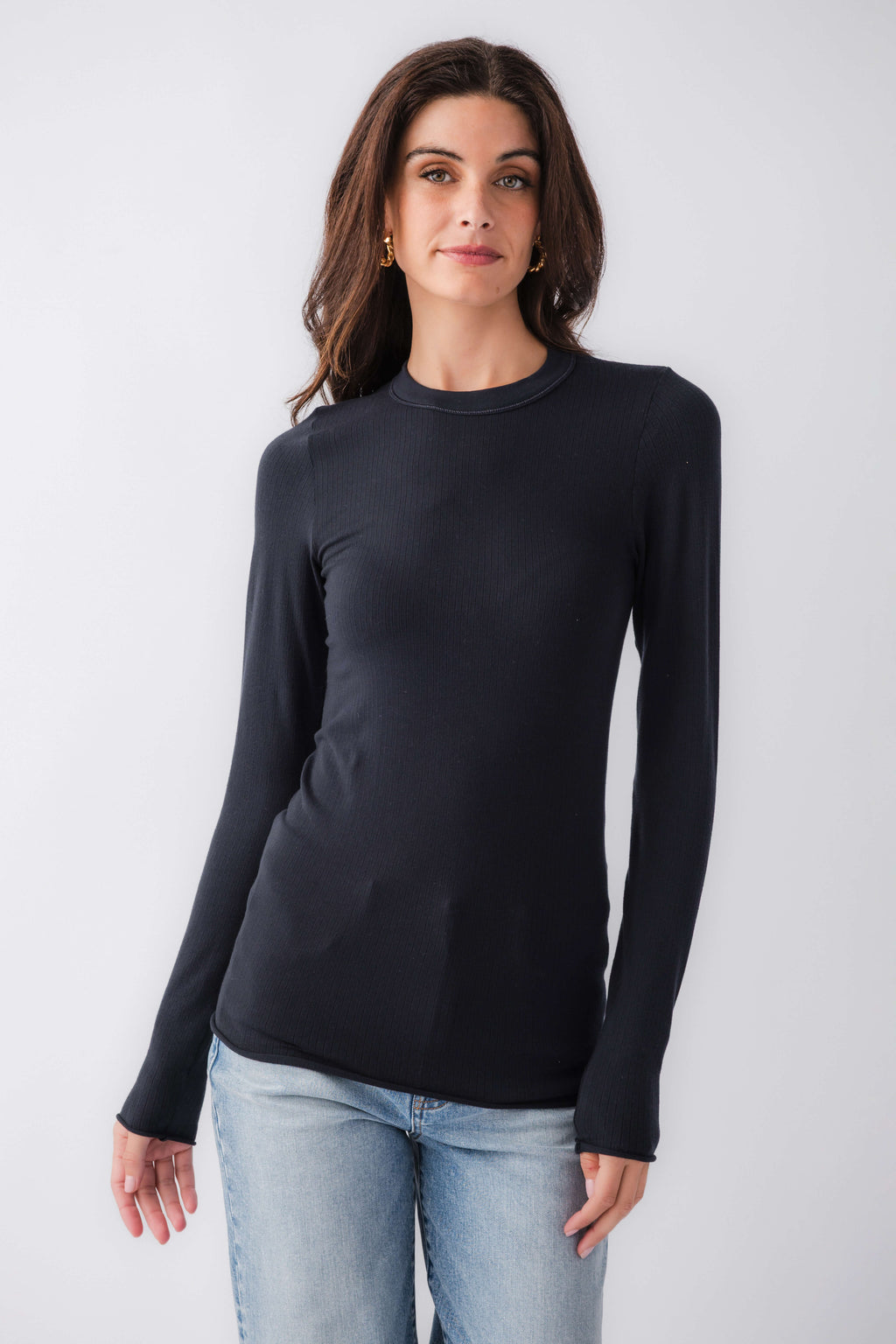 Black seamless long sleeve top with crew neck, fitted stretch knit