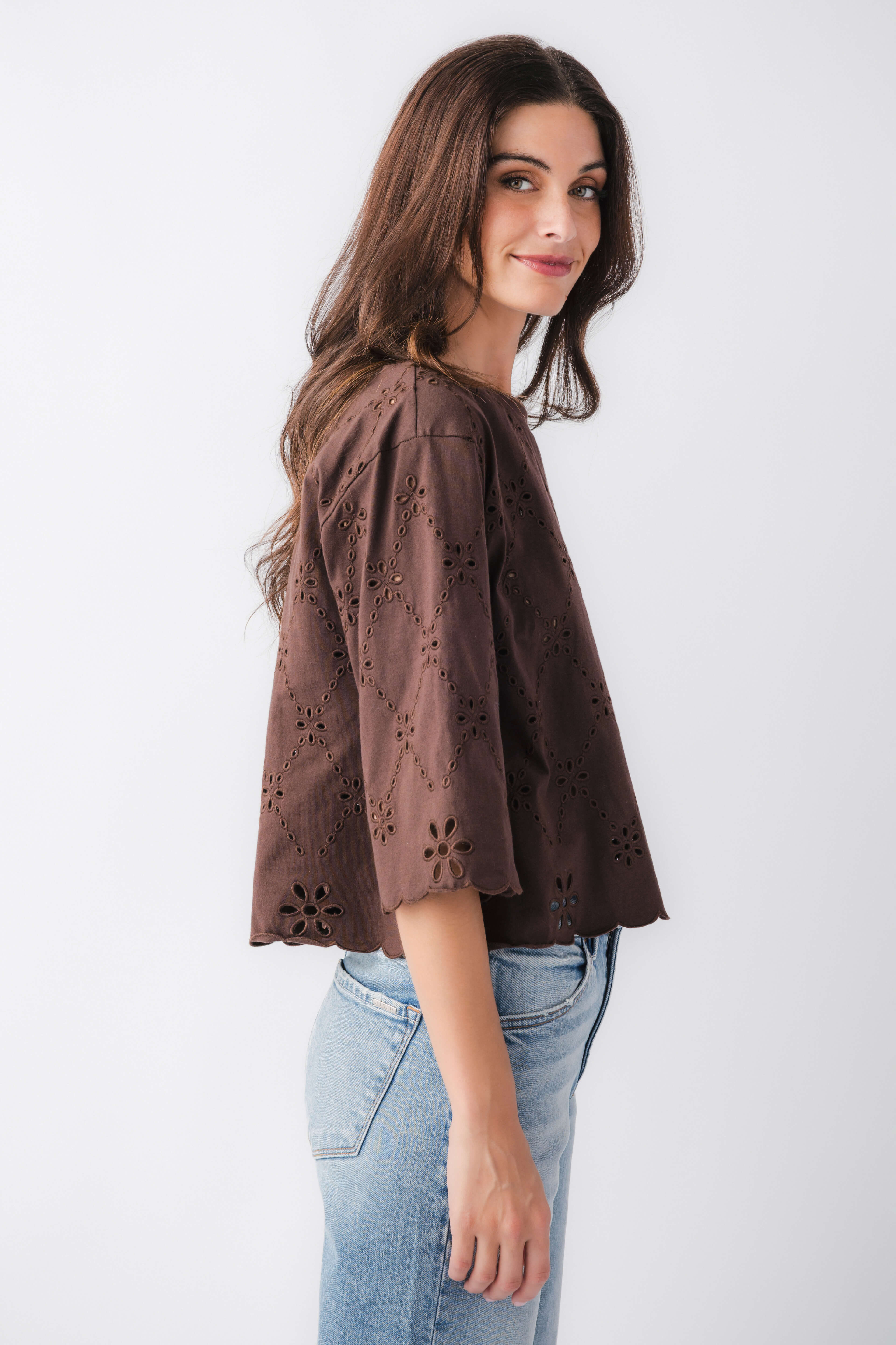 Brown eyelet scallop top with lace-like cutout embroidery and scalloped hem, side view