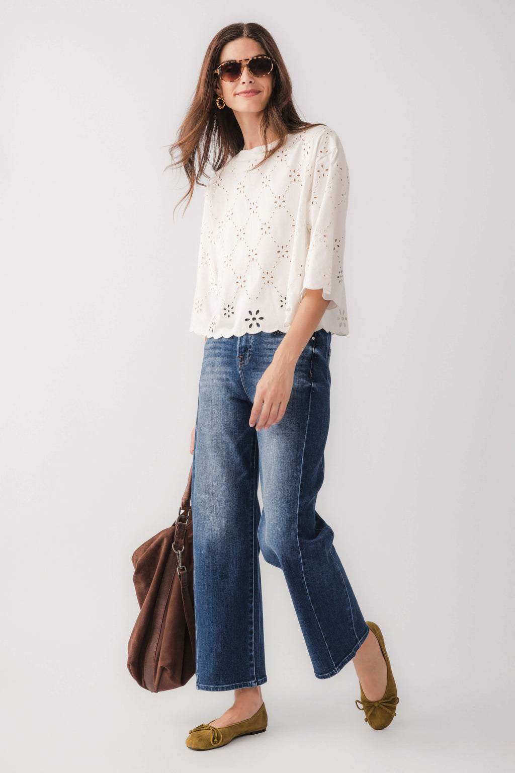 Ivory eyelet scallop top with floral cutout pattern and scalloped hem, side view