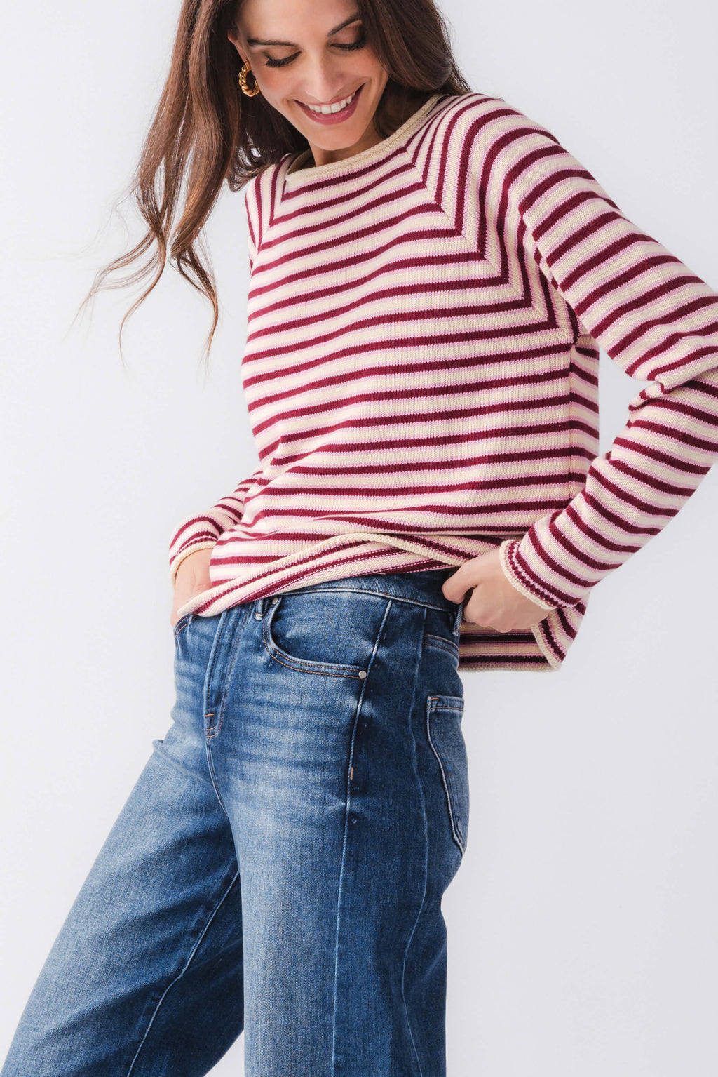 Close-up burgundy and pink striped mockneck sweater with ribbed cuffs