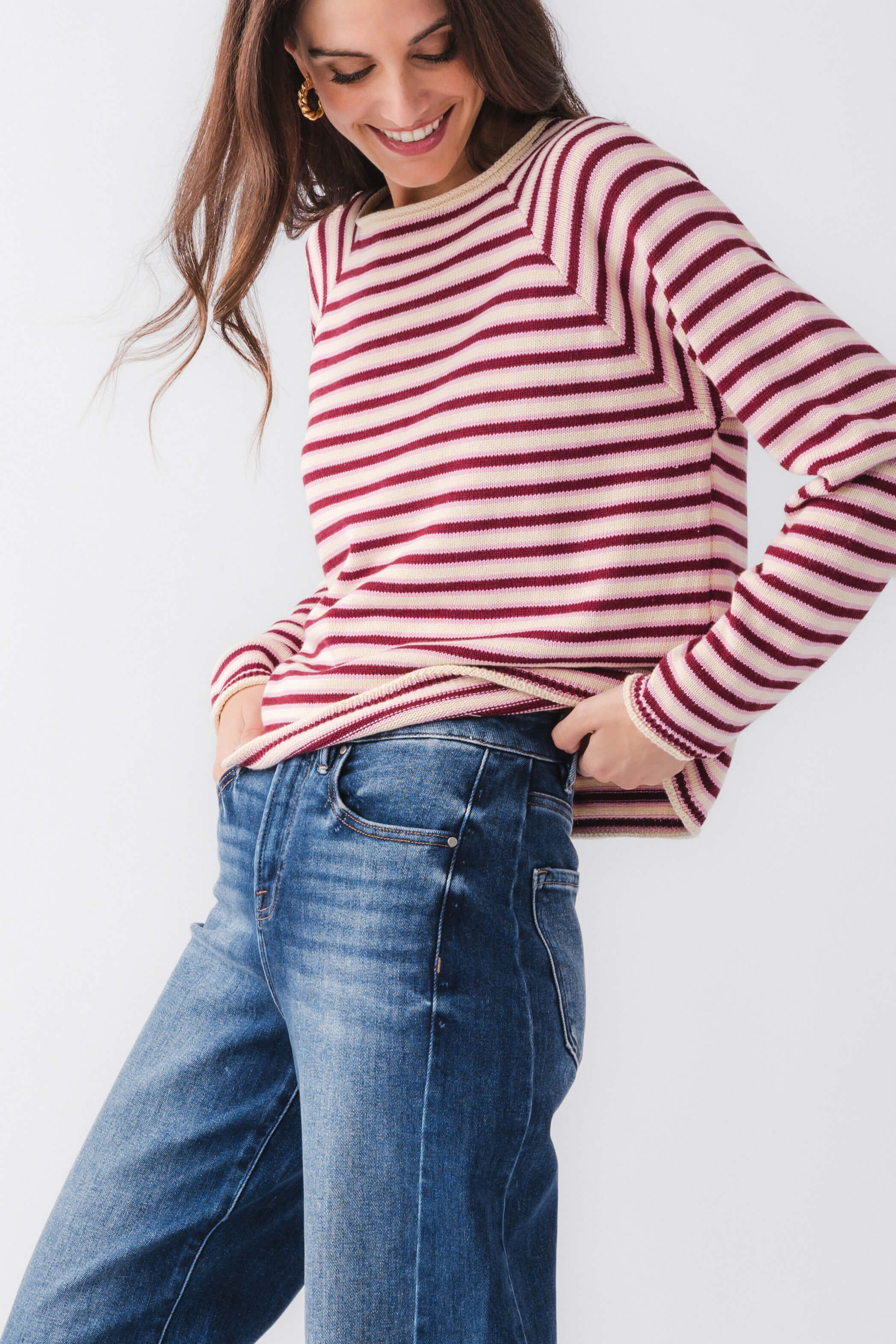 Close-up burgundy and pink striped mockneck sweater with ribbed cuffs