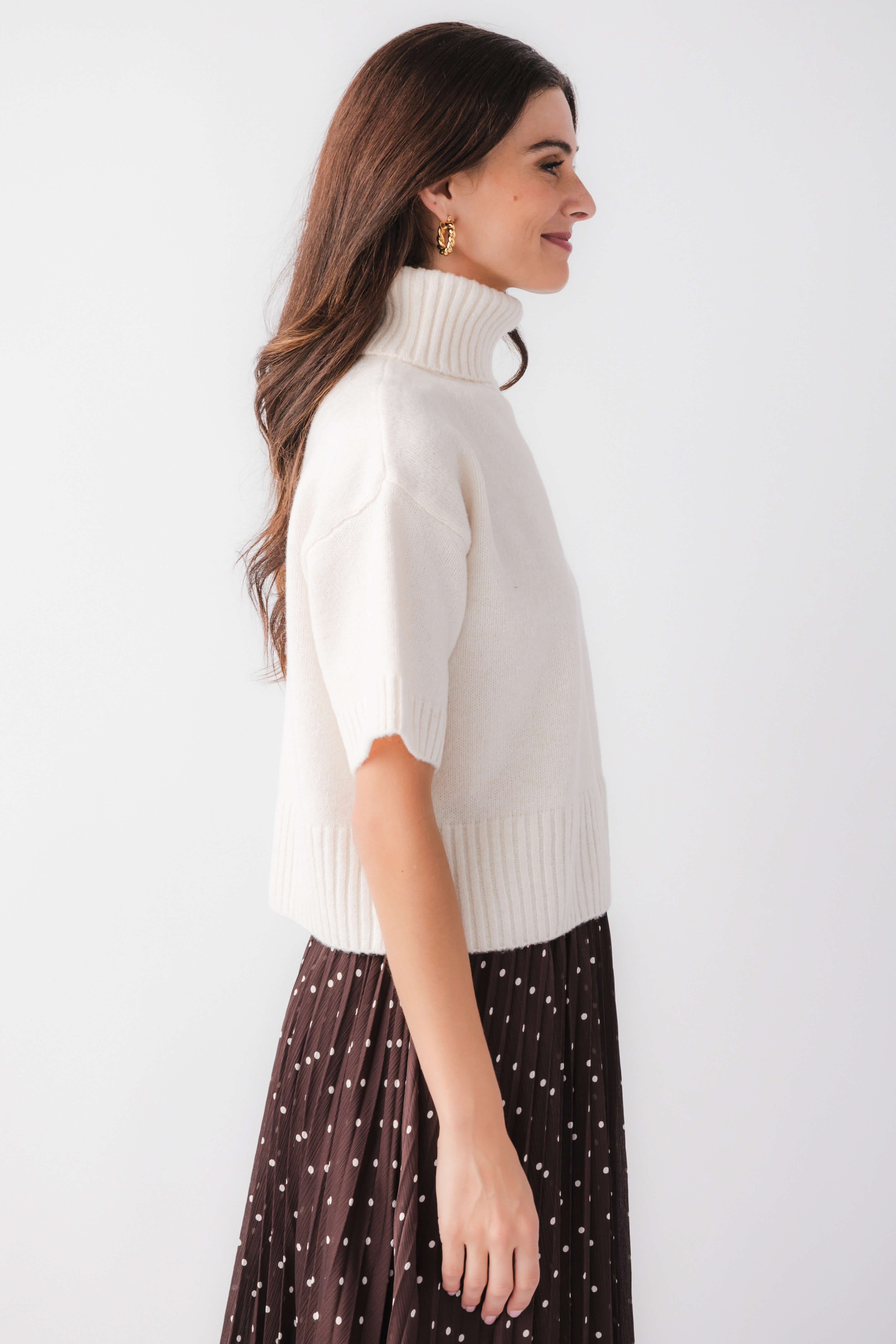 Off-white short-sleeve turtleneck knit sweater, side view, ribbed knit trim