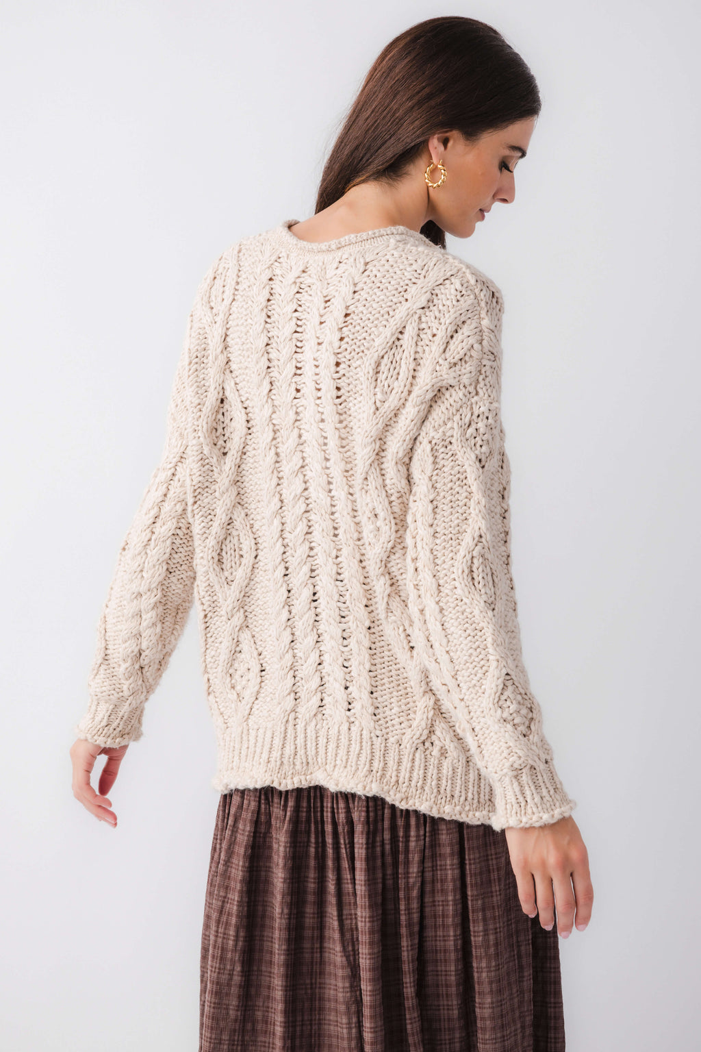 Cream cable-knit cardigan with long sleeves, textured back design
