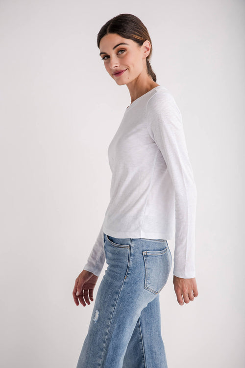 White long-sleeve crewneck slub tee, side view with smooth sleeves.