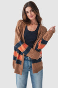 Brown open-front varsity cardigan with cable knit texture and navy/orange stripe bands