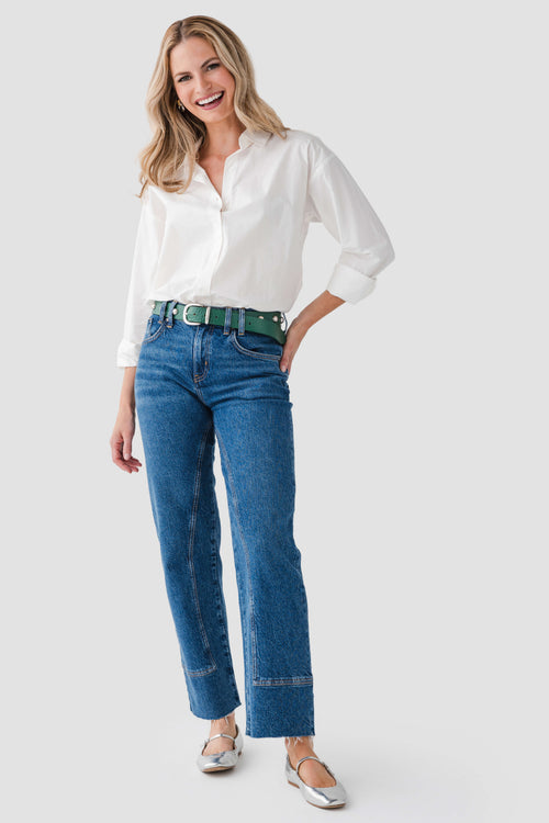Blue jeans with emerald studded belt and metal buckle at the waist