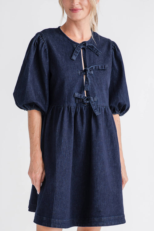 Dark denim babydoll mini dress with ribbon tie neckline and puff sleeves, close-up
