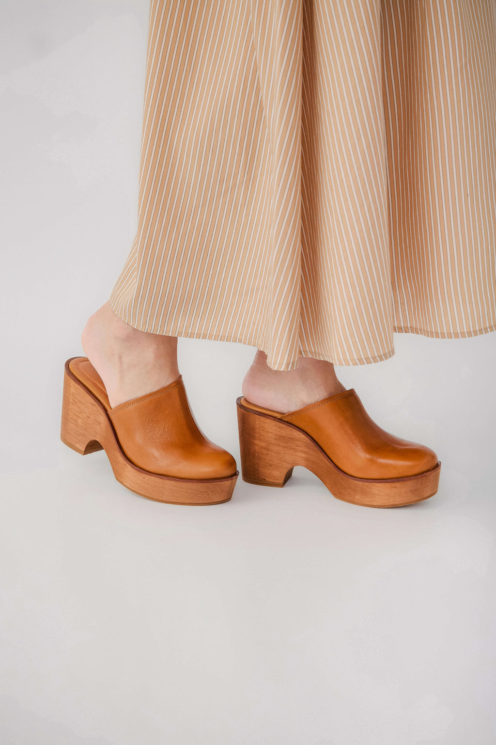 Tan leather wedge clog mules with rounded toe and thick block heel