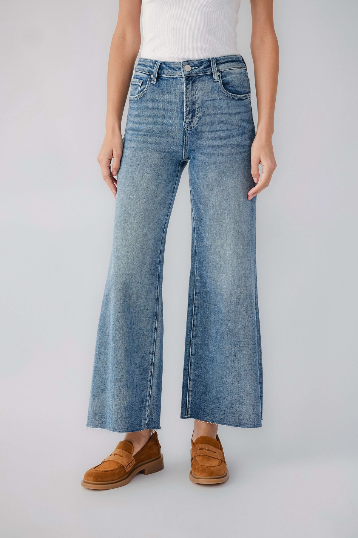 Light blue wide-leg denim jeans with raw hem and classic five-pocket styling