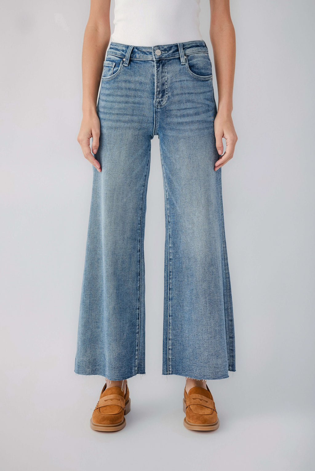 Medium blue wide-leg denim jeans with raw hem and visible belt loops