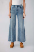 Medium blue wide-leg denim jeans with raw hem and visible belt loops