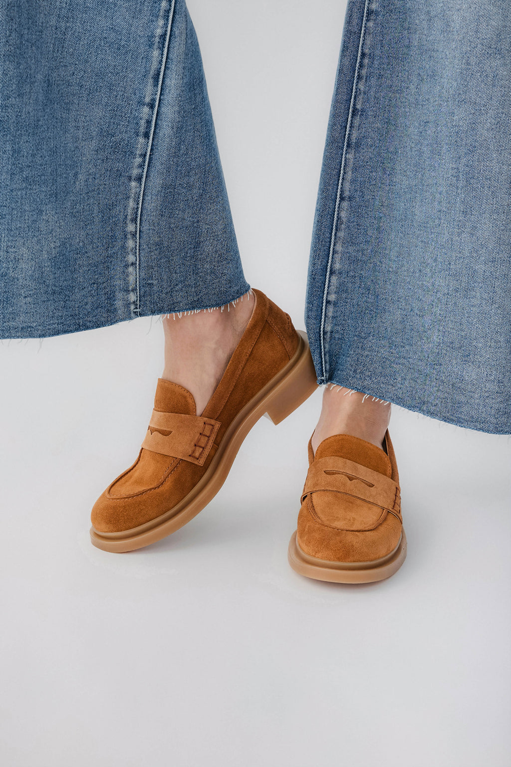 Tan suede loafer with slip-on strap and cushioned sole