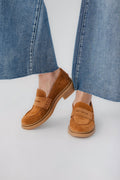 Tan suede loafer with slip-on strap and cushioned sole