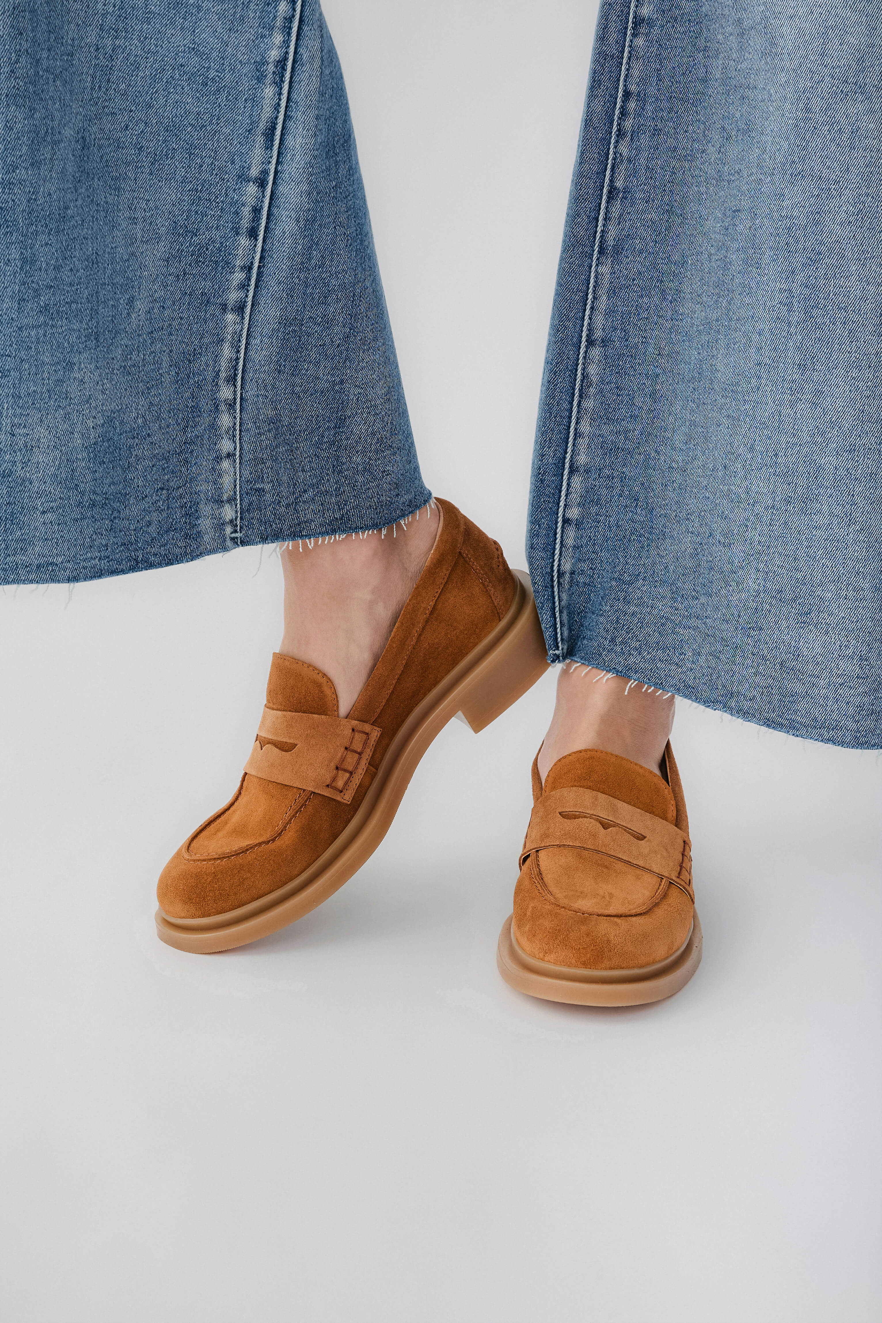 Tan suede loafer with slip-on strap and cushioned sole