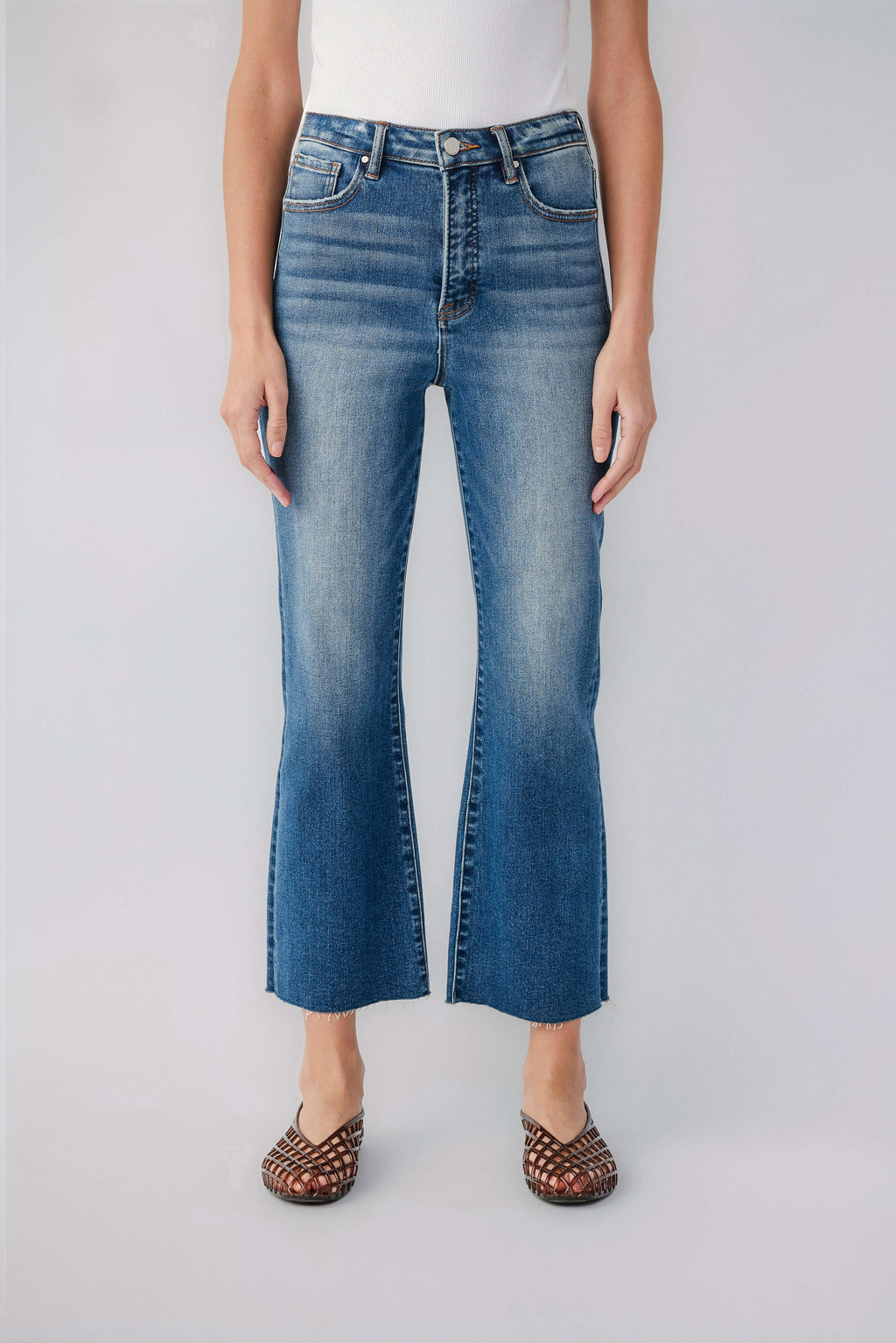 High-rise kick flare jeans in light blue wash, front button, belt loops, whisker detail