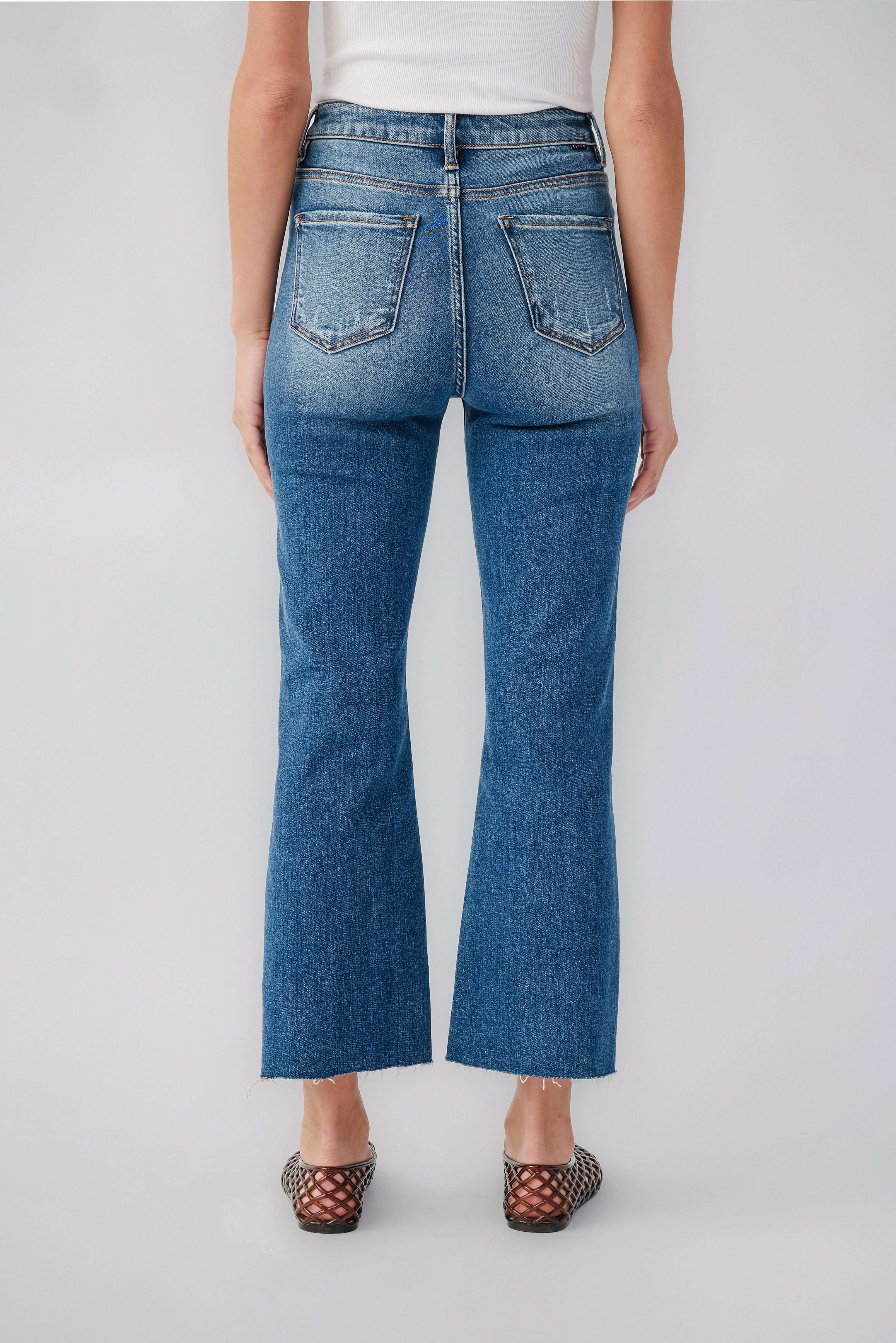 High-rise kick flare jeans in medium blue denim, rear pockets, belt loops, zip fly