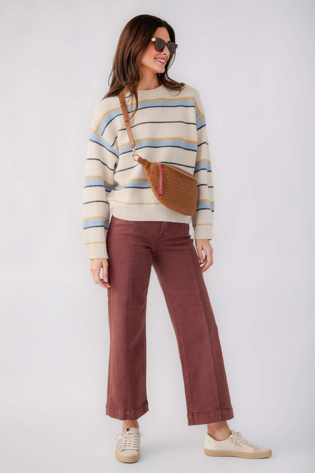 Striped crewneck knit sweater with blue and yellow bands, long sleeves