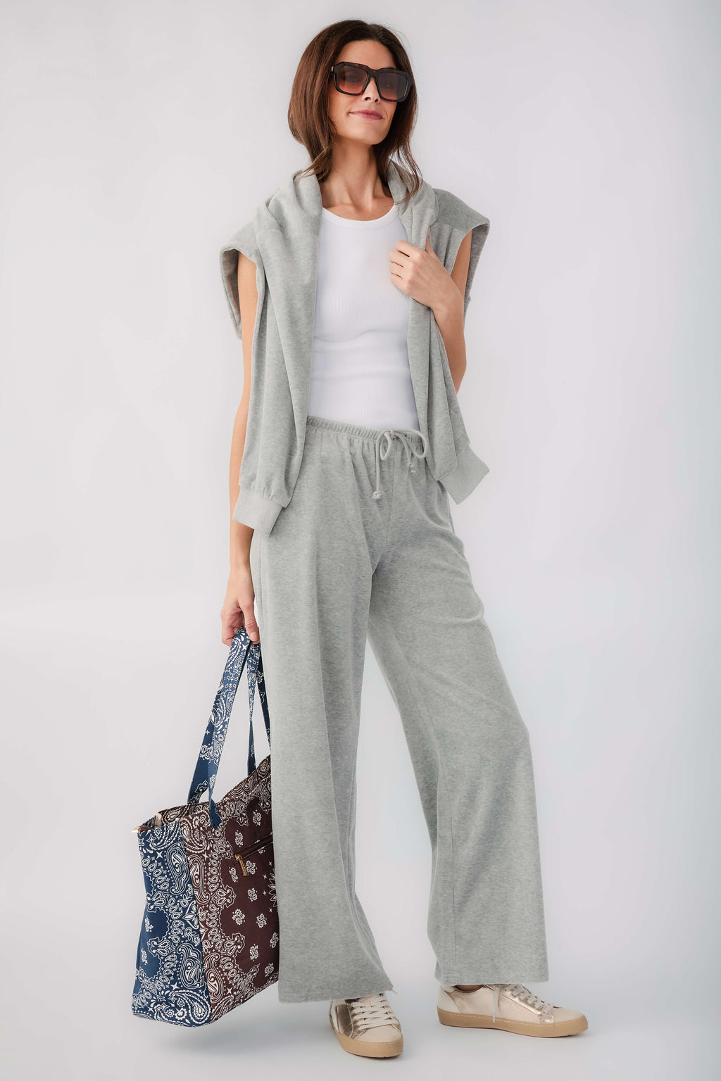 Bandana print tote bag in brown and navy, carried with long handles over the shoulder