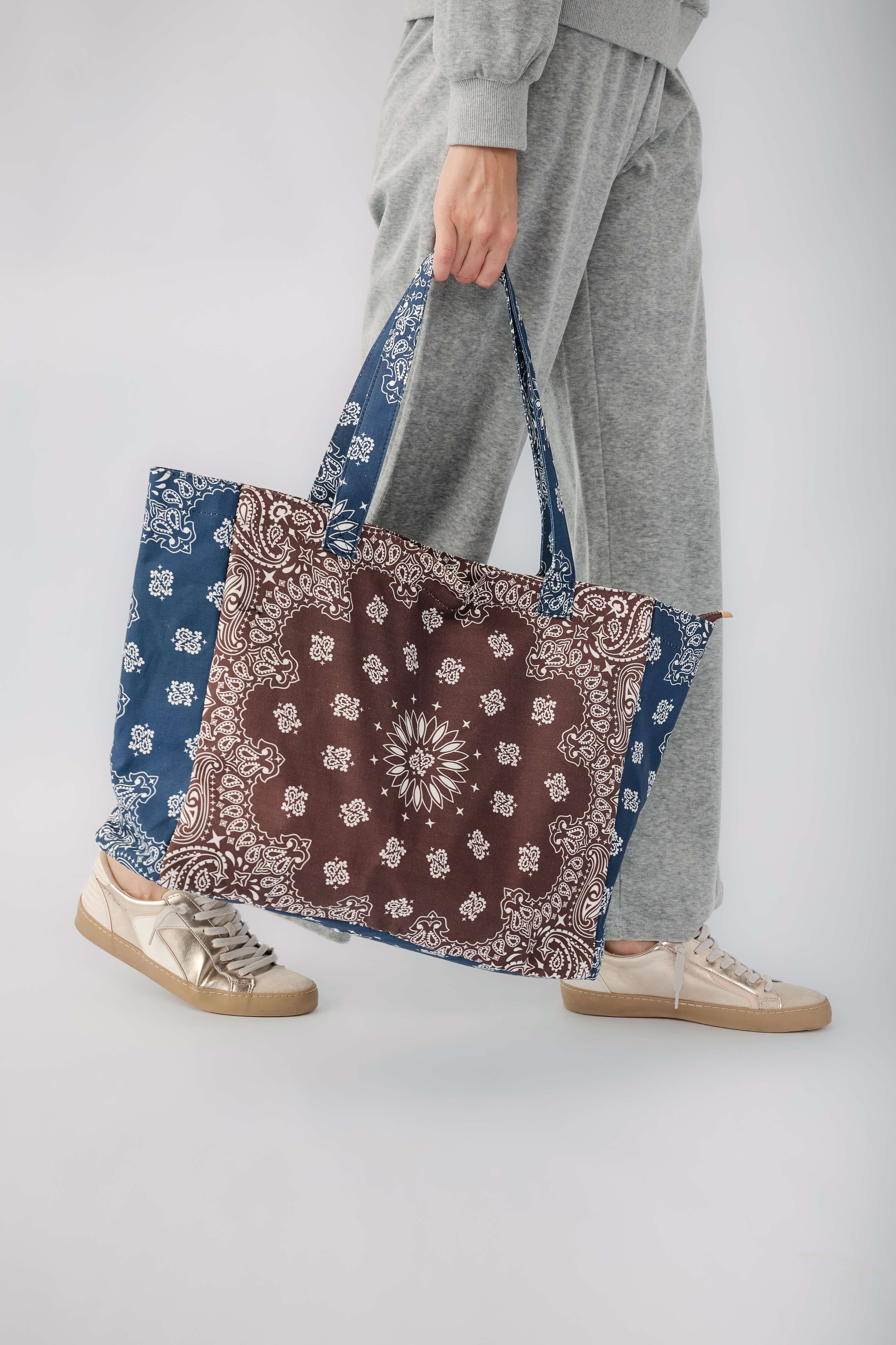 Brown and navy bandana print tote bag with long blue-trimmed handles