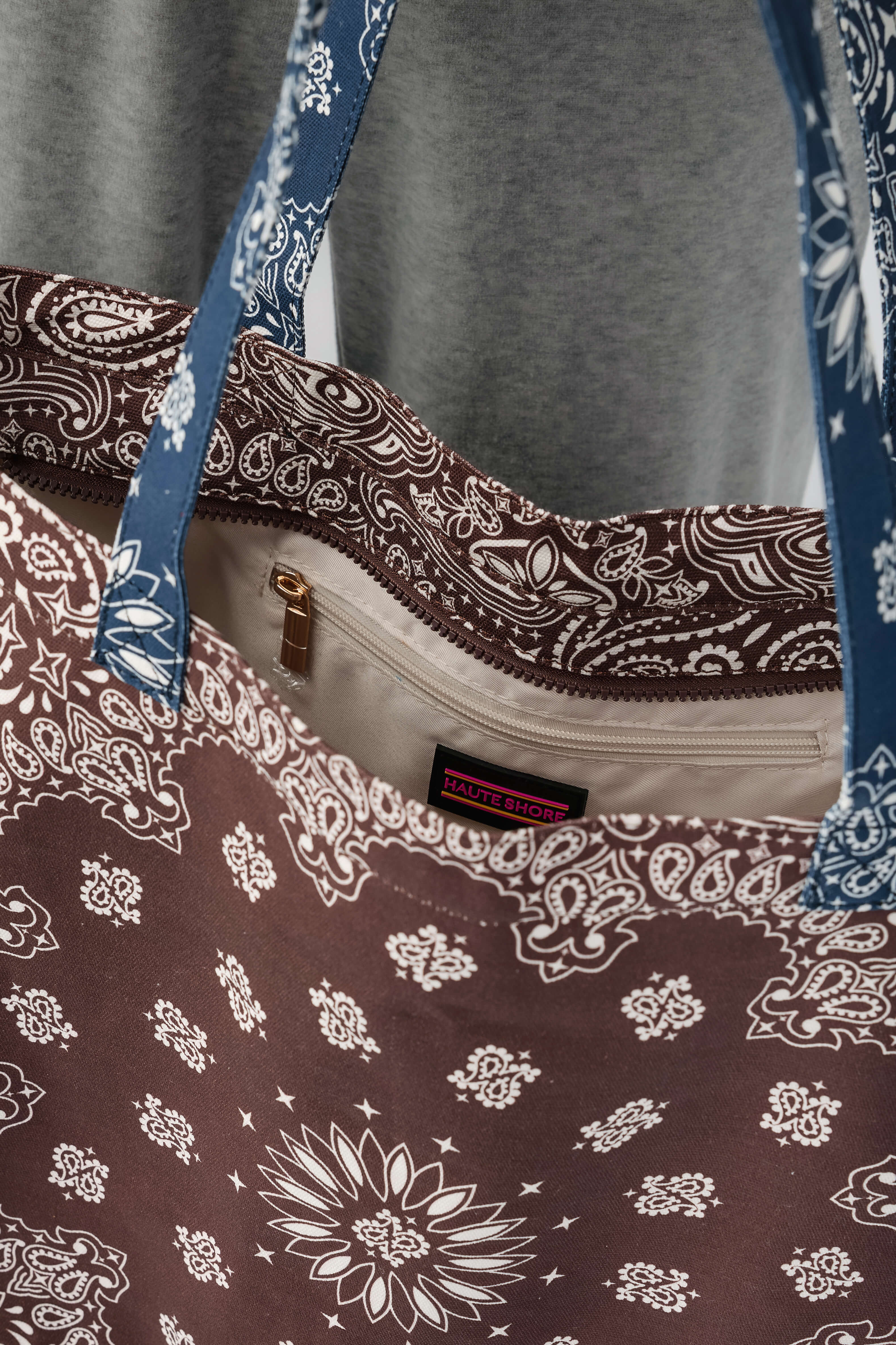 Bandana print tote bag with front zip pocket and brown-and-navy paisley pattern