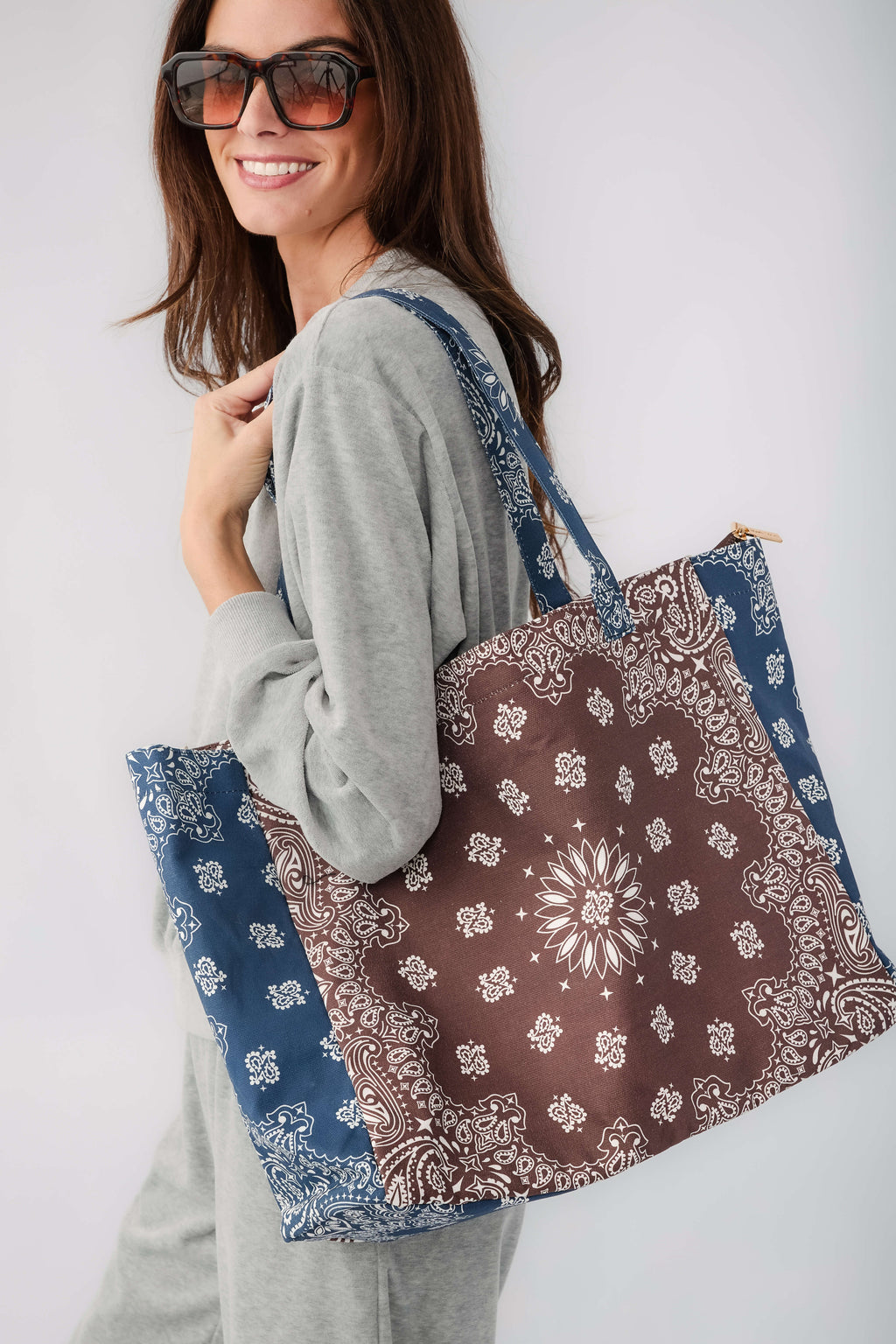 Bandana print tote bag in brown and navy with patterned side panels and long handles