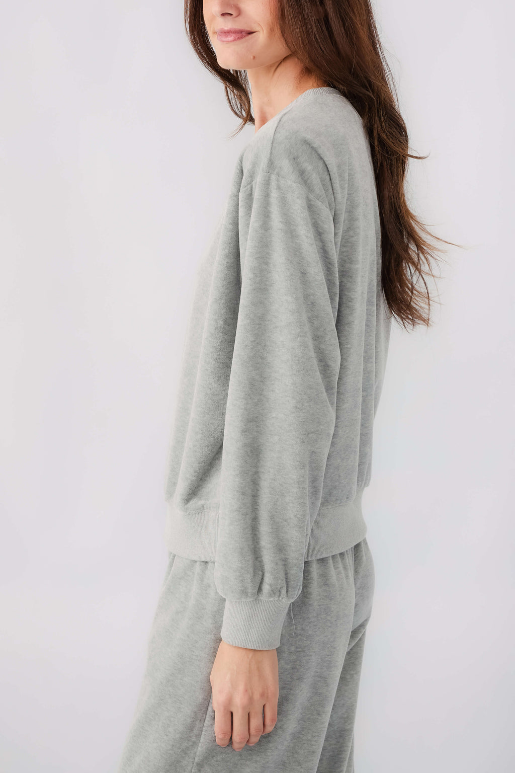 Grey velour sweatshirt and drawstring sweatpants, side view with ribbed cuffs