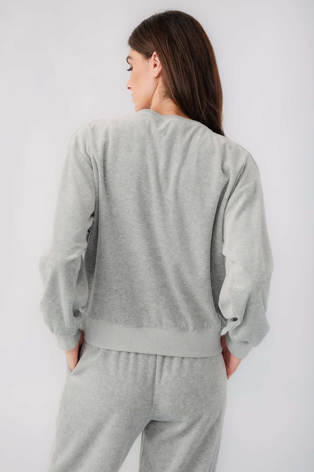 Grey velour sweatshirt back view with long sleeves and ribbed hem, plus sweatpants