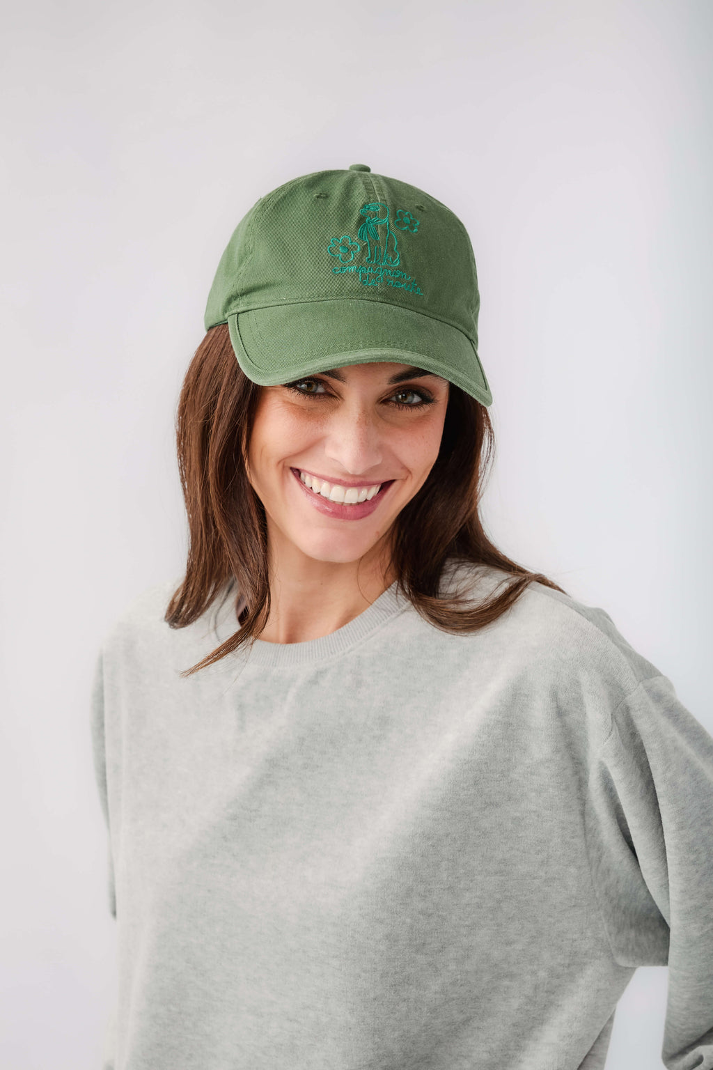 Green baseball cap with blue embroidered logo