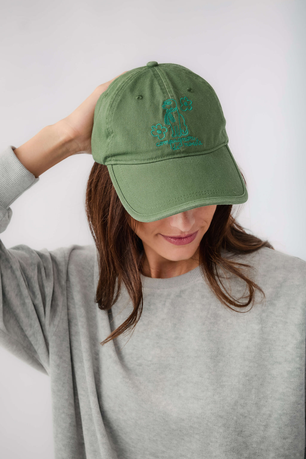Green baseball cap with blue side embroidered logo