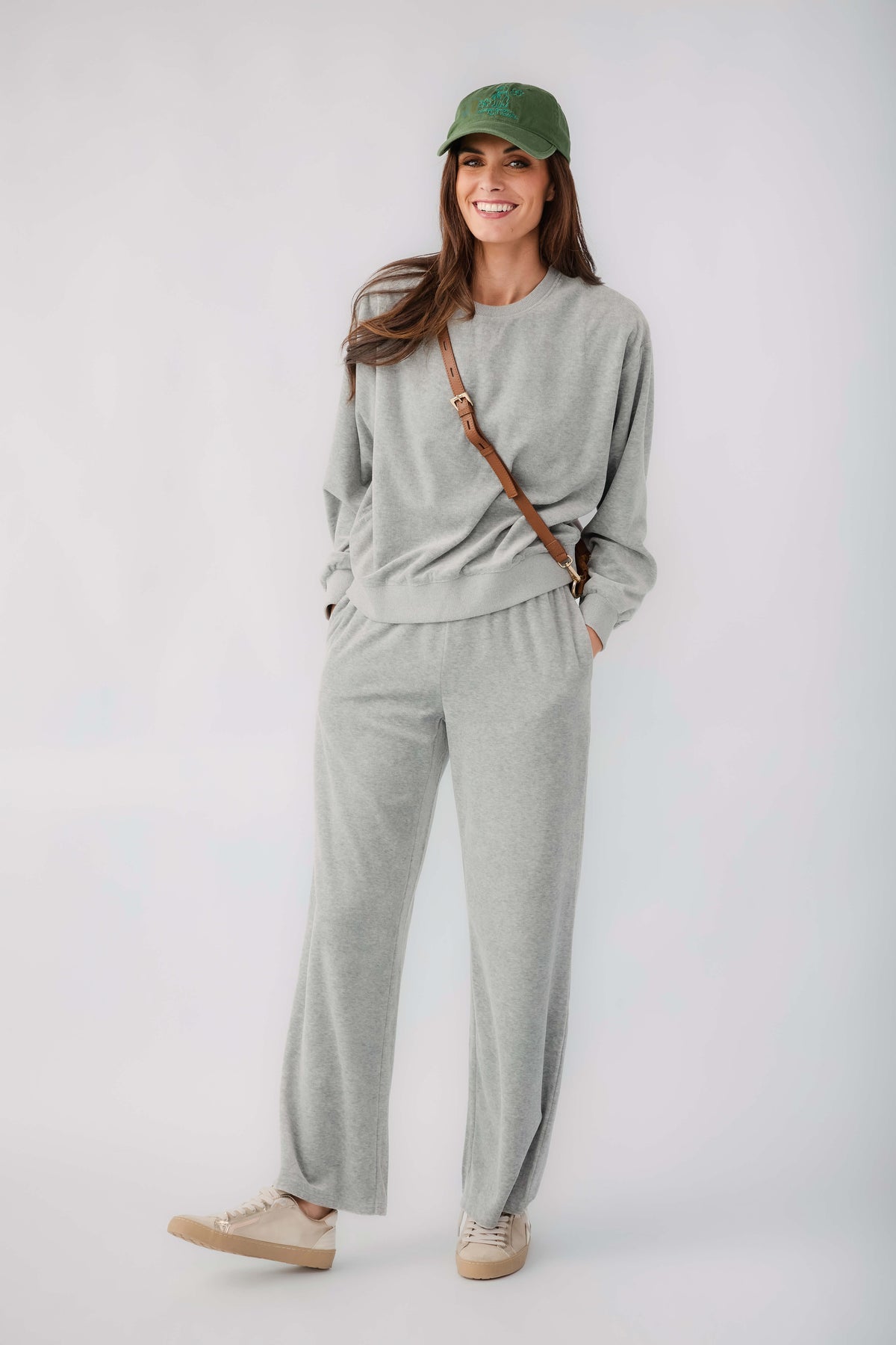 Grey velour pullover sweatshirt and matching drawstring sweatpants, front view
