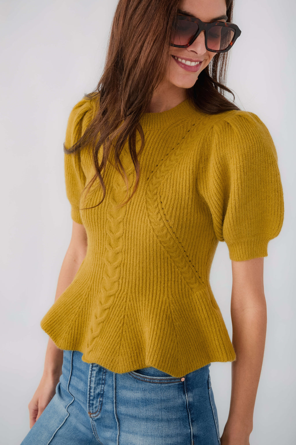 Chartreuse knit top with puff sleeves and textured cable pattern, flared hem